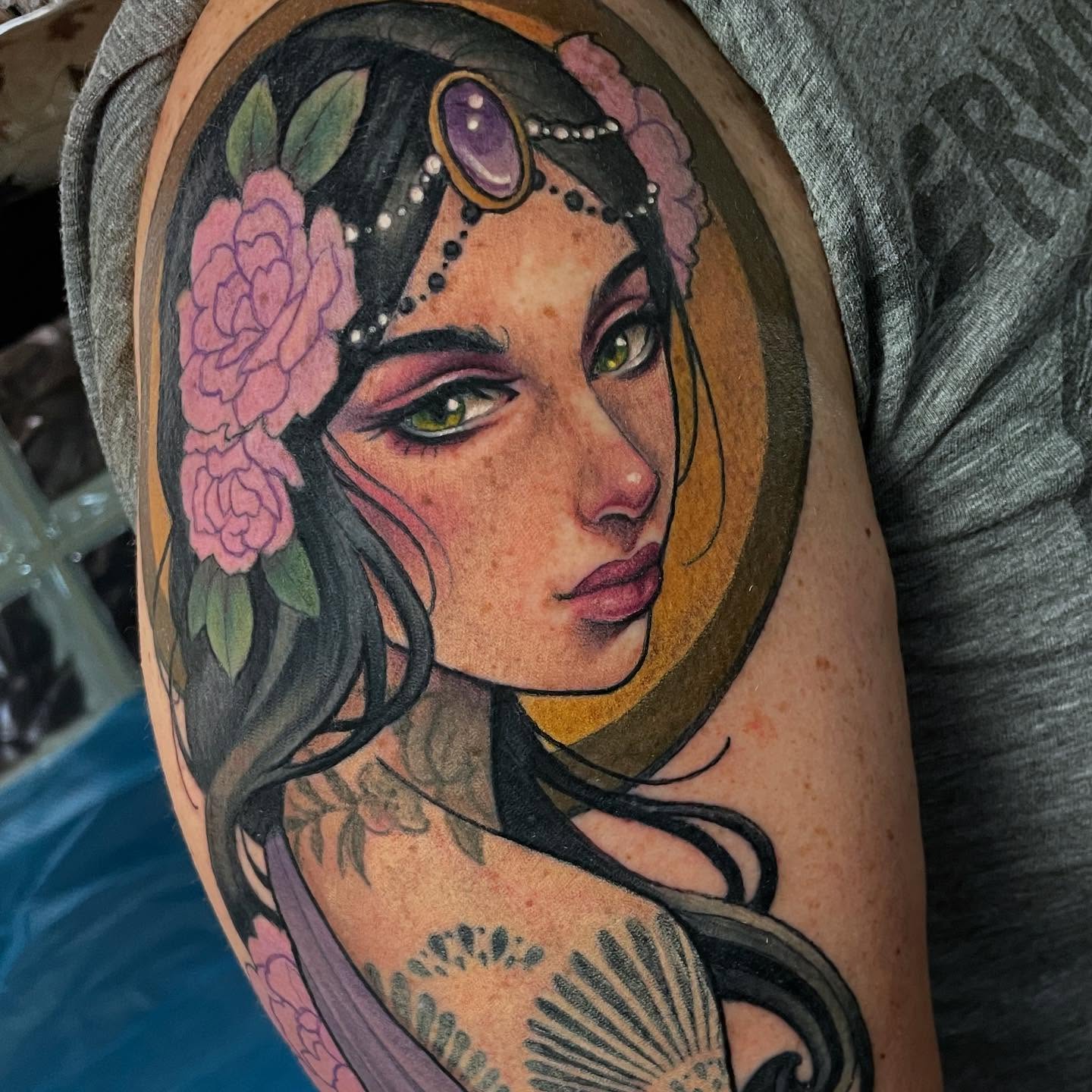 Woman with flowers realism tattoo on the upper arm by Leah Marie, Cincinnati