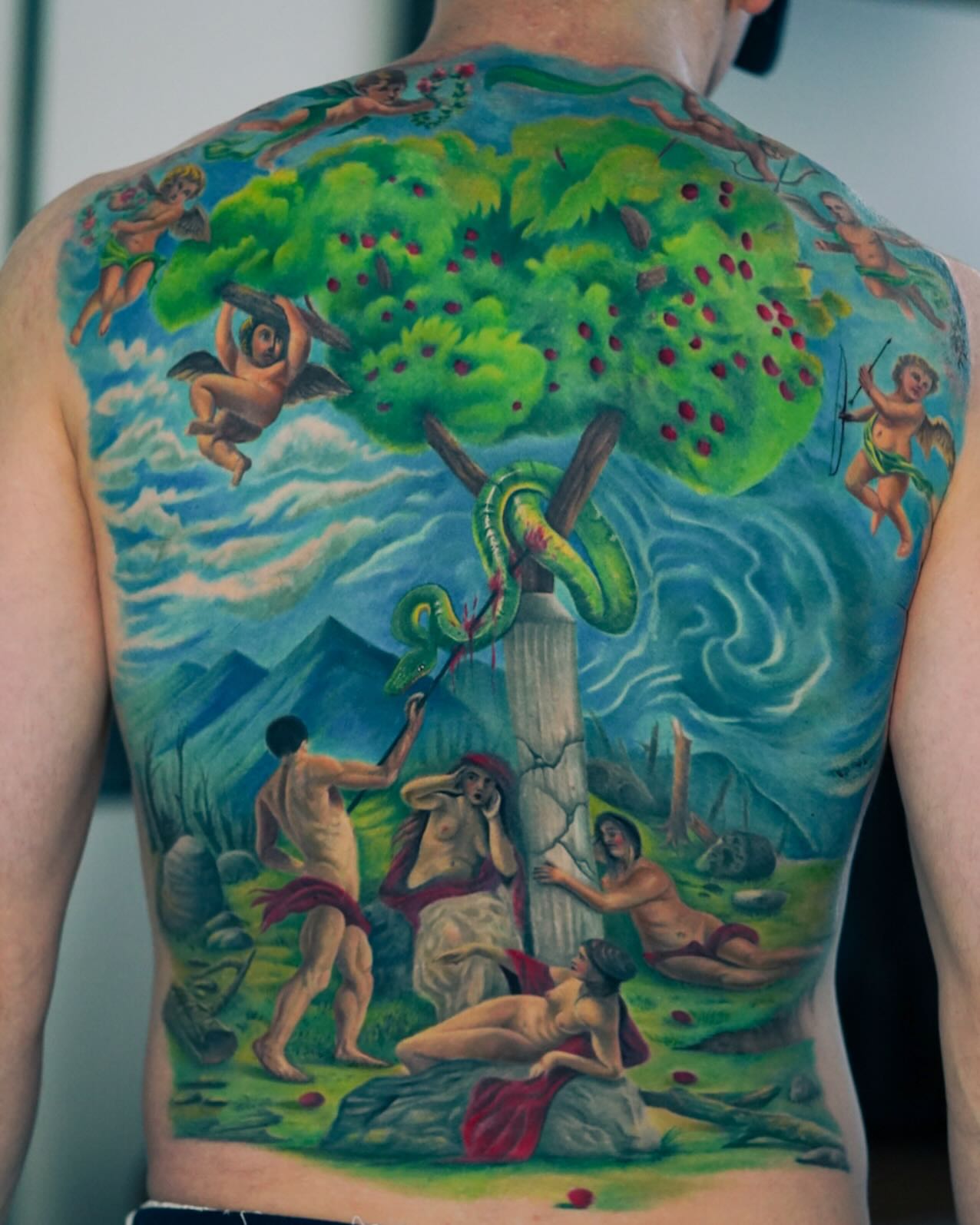 The fall of adam and eve illustrative tattoo on the back by David Gordon