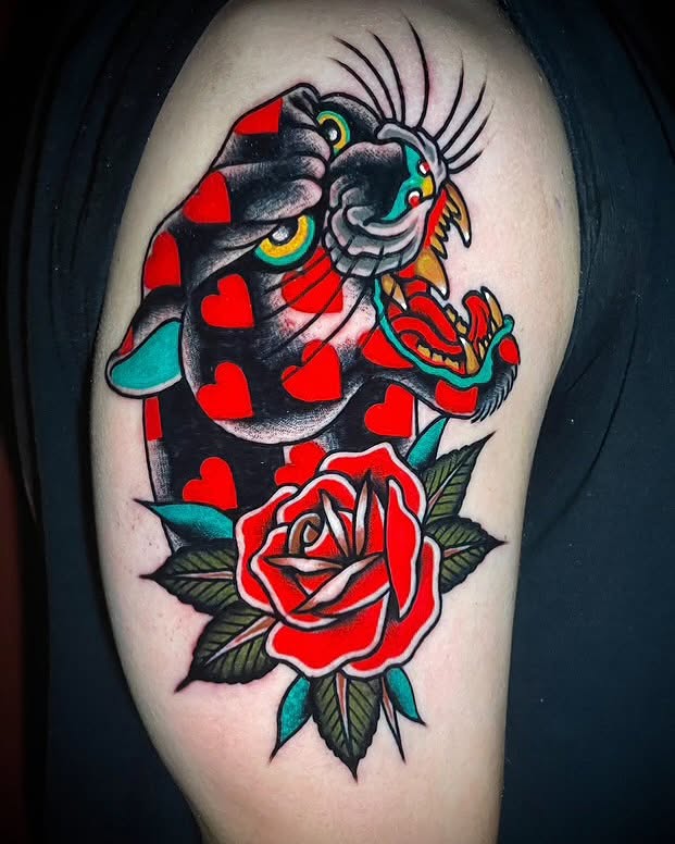 Cat and rose American traditional tattoo on the shoulder by Alex Muniz