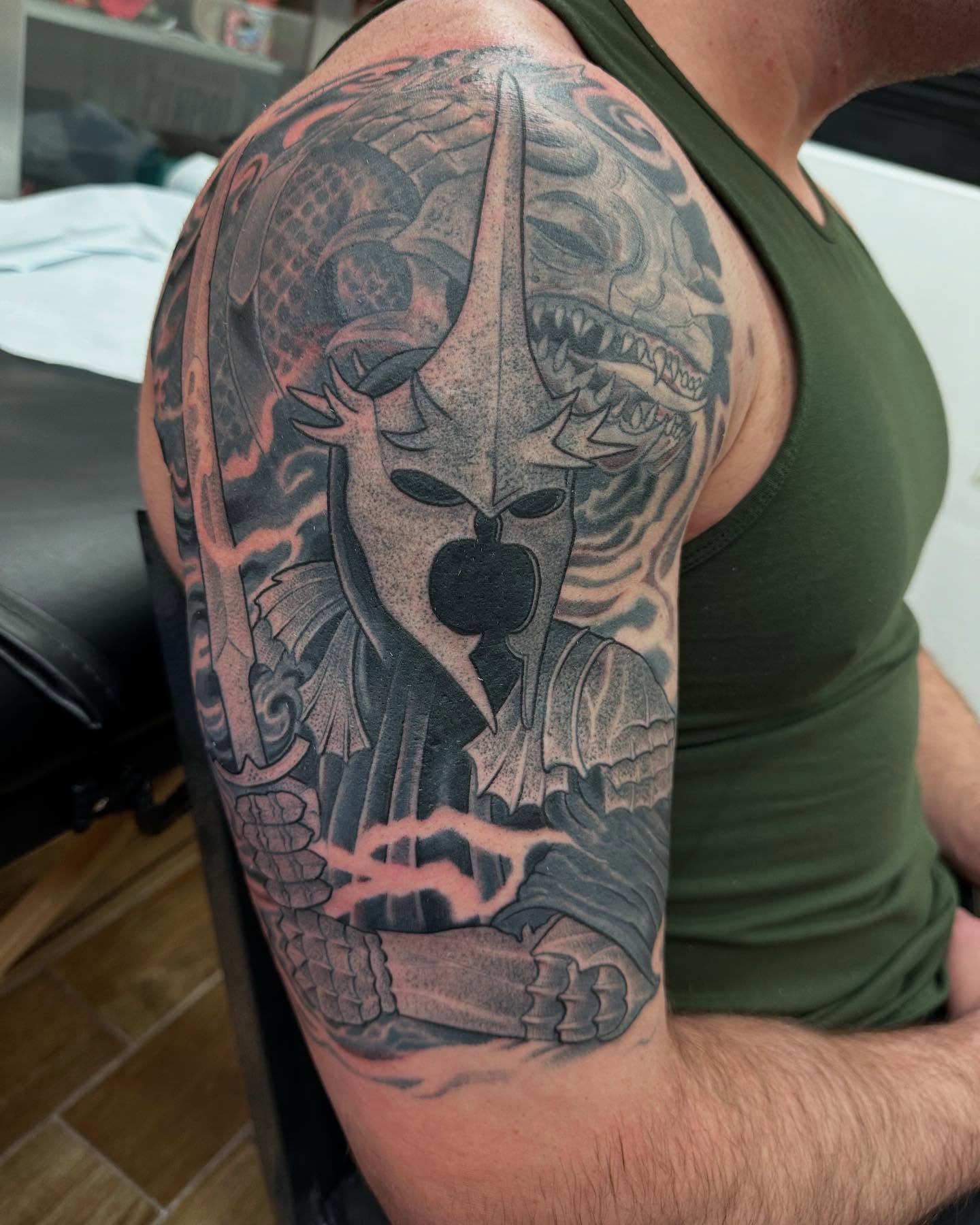 Warrior helmet black and grey tattoo on the upper arm by Hori Bensei, Charlottesville, Virginia