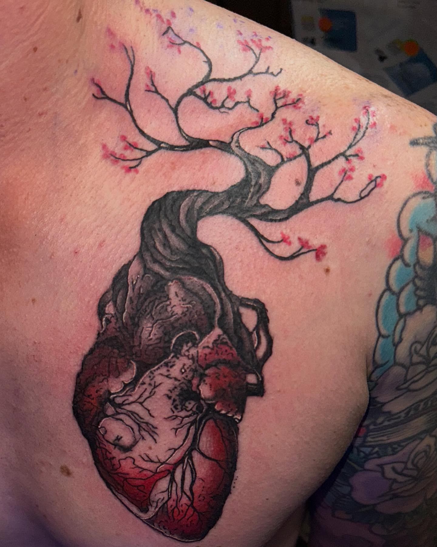 Heart and cherry blossom tree realism tattoo on the shoulder by Therapy ink