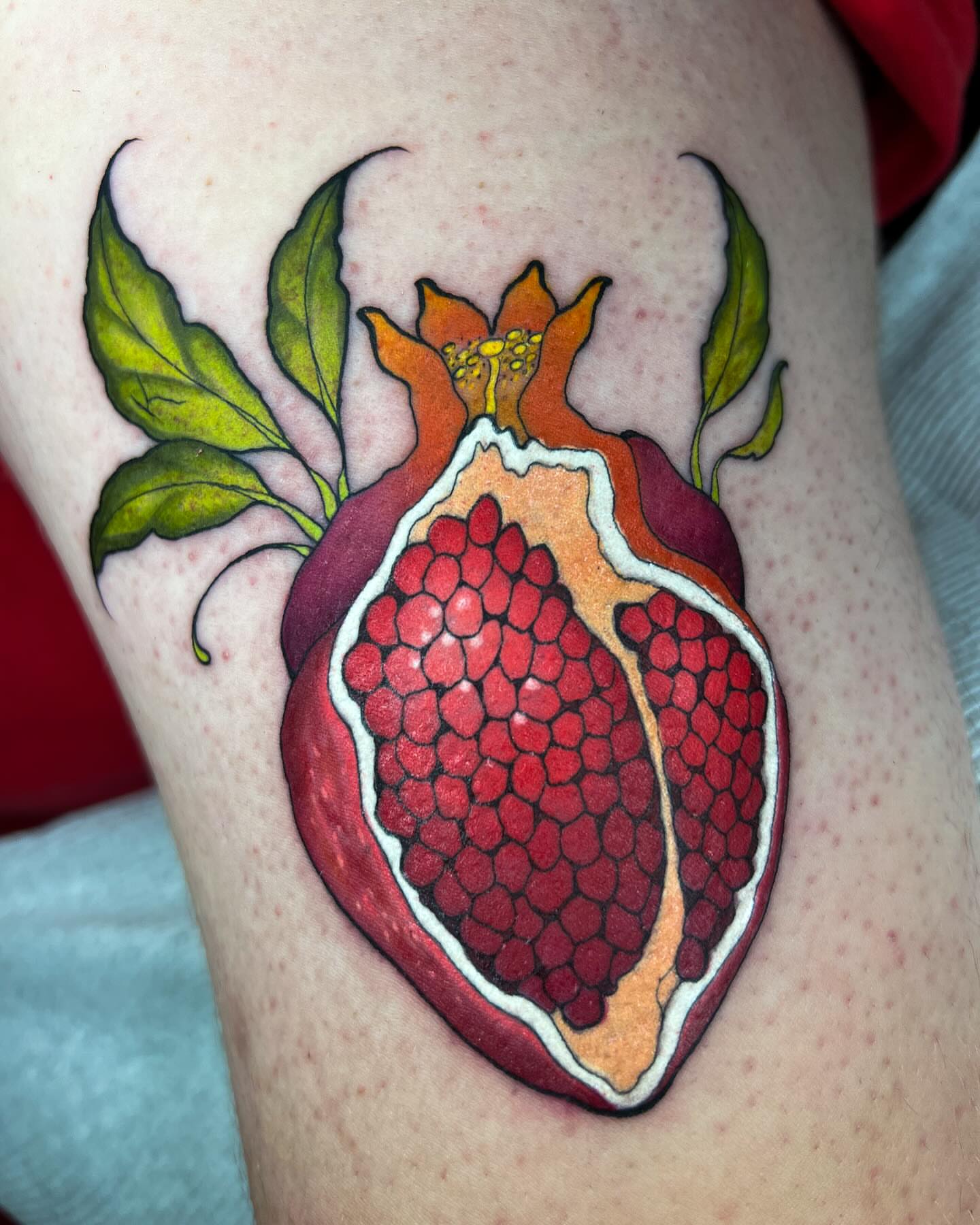 Pomegranate dotwork tattoo on the thigh by Severin Black