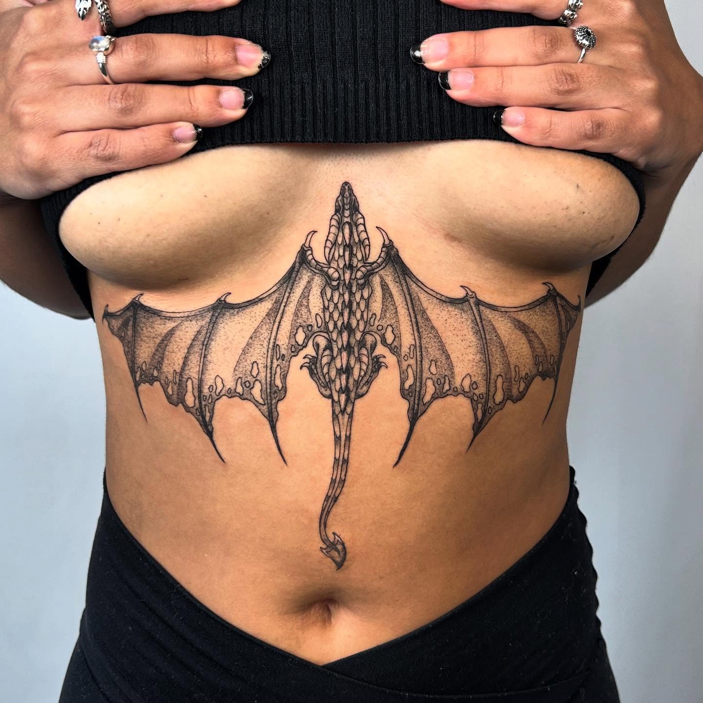 Dragon dotwork tattoo on the ribs by Nikki Power