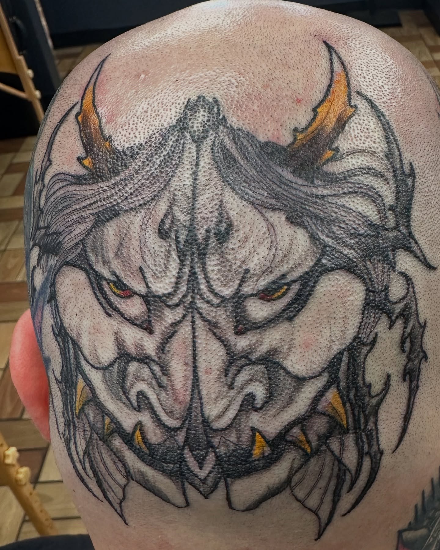 Demon face dotwork tattoo on the shoulder by vannadoestattoos