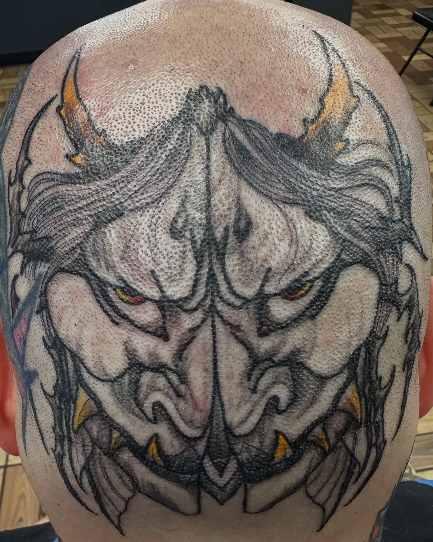 Demon face dotwork tattoo on the head by vannadoestattoos
