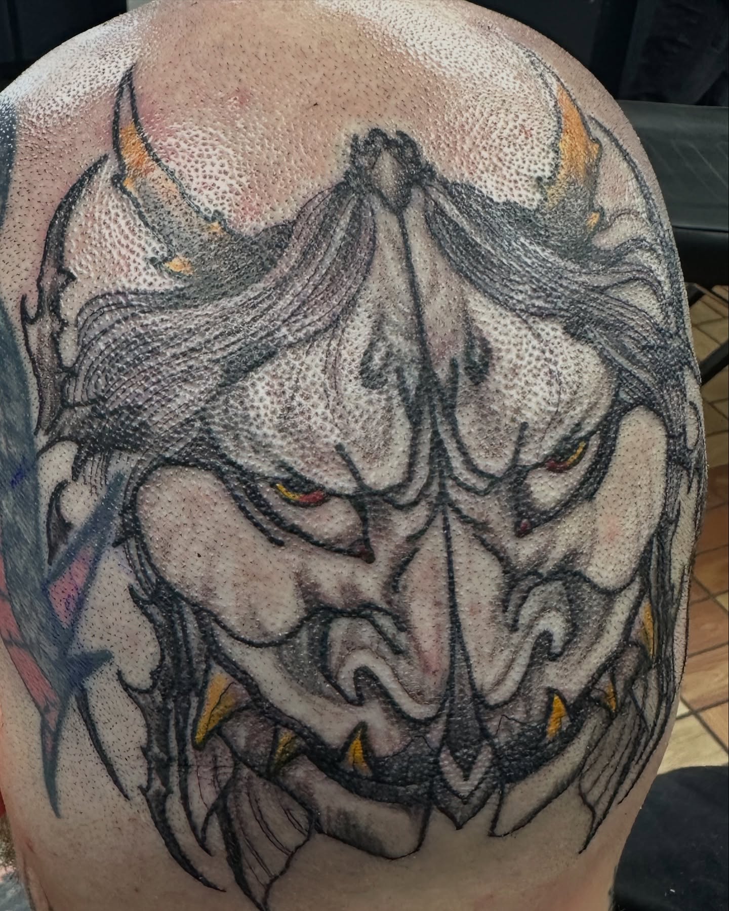 Demon face dotwork tattoo on the back by vannadoestattoos