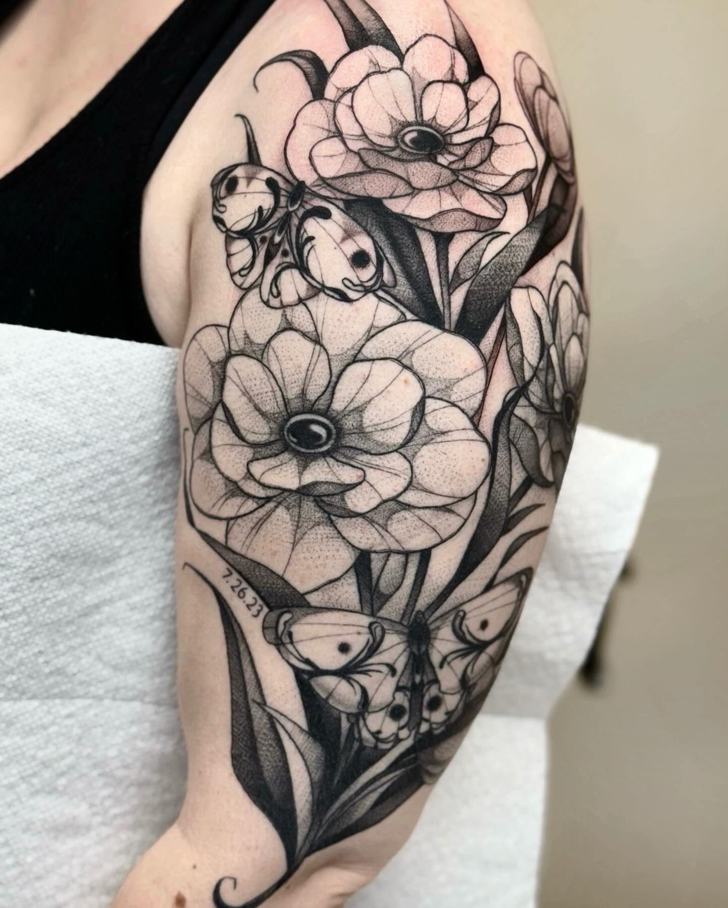 Flowers and butterflies dotwork tattoo on the forearm by jada
