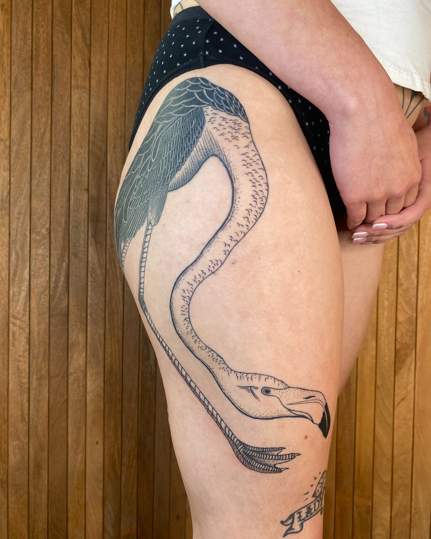 Bird black and grey tattoo on the thigh by Avery Kane