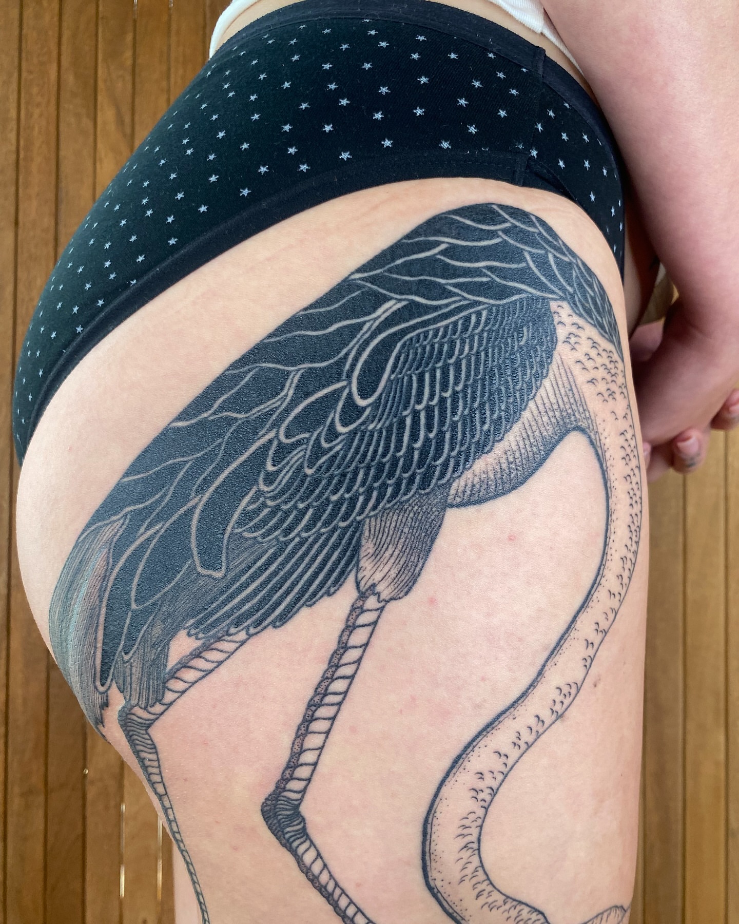 Heron black and grey tattoo on the thigh by Avery Kane