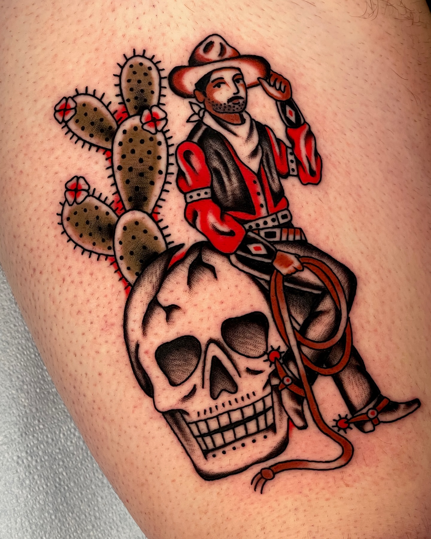 Cowboy on skull American traditional tattoo on the thigh by Chase Tucker