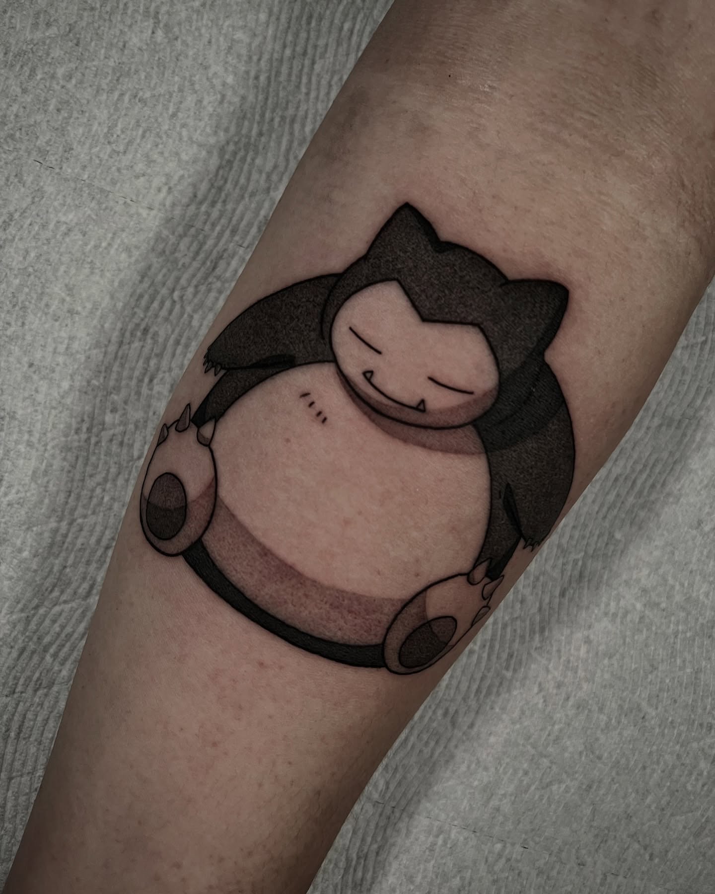 Snorlax black and grey tattoo on the forearm by Chandler Roe