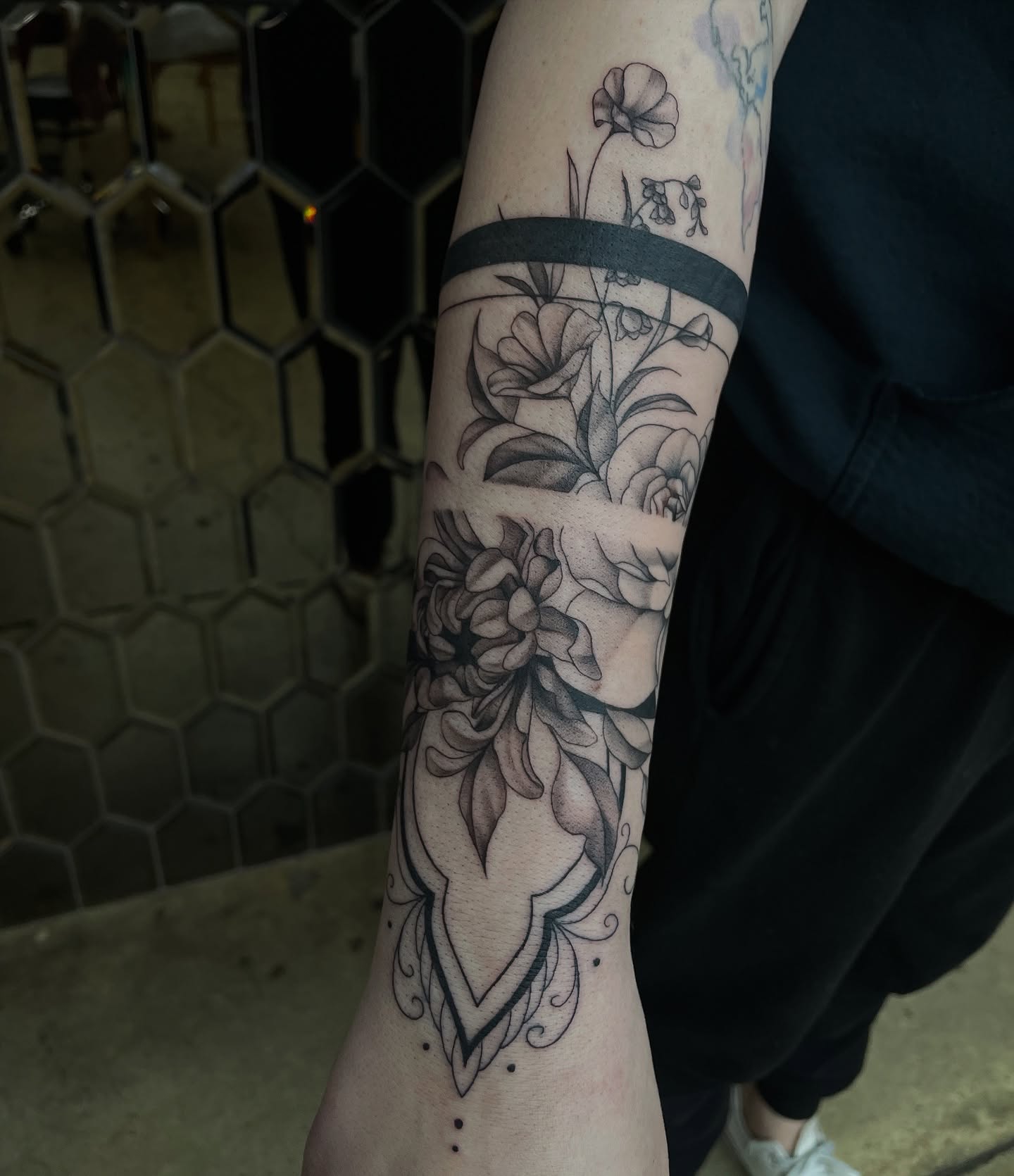 Floral bouquet black and grey tattoo on the forearm by kaylee