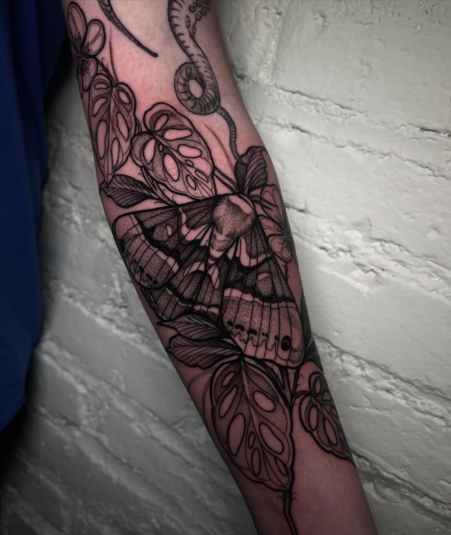 Butterfly and flowers realism tattoo on the forearm by H A N N A H, Colorado Springs, Colorado