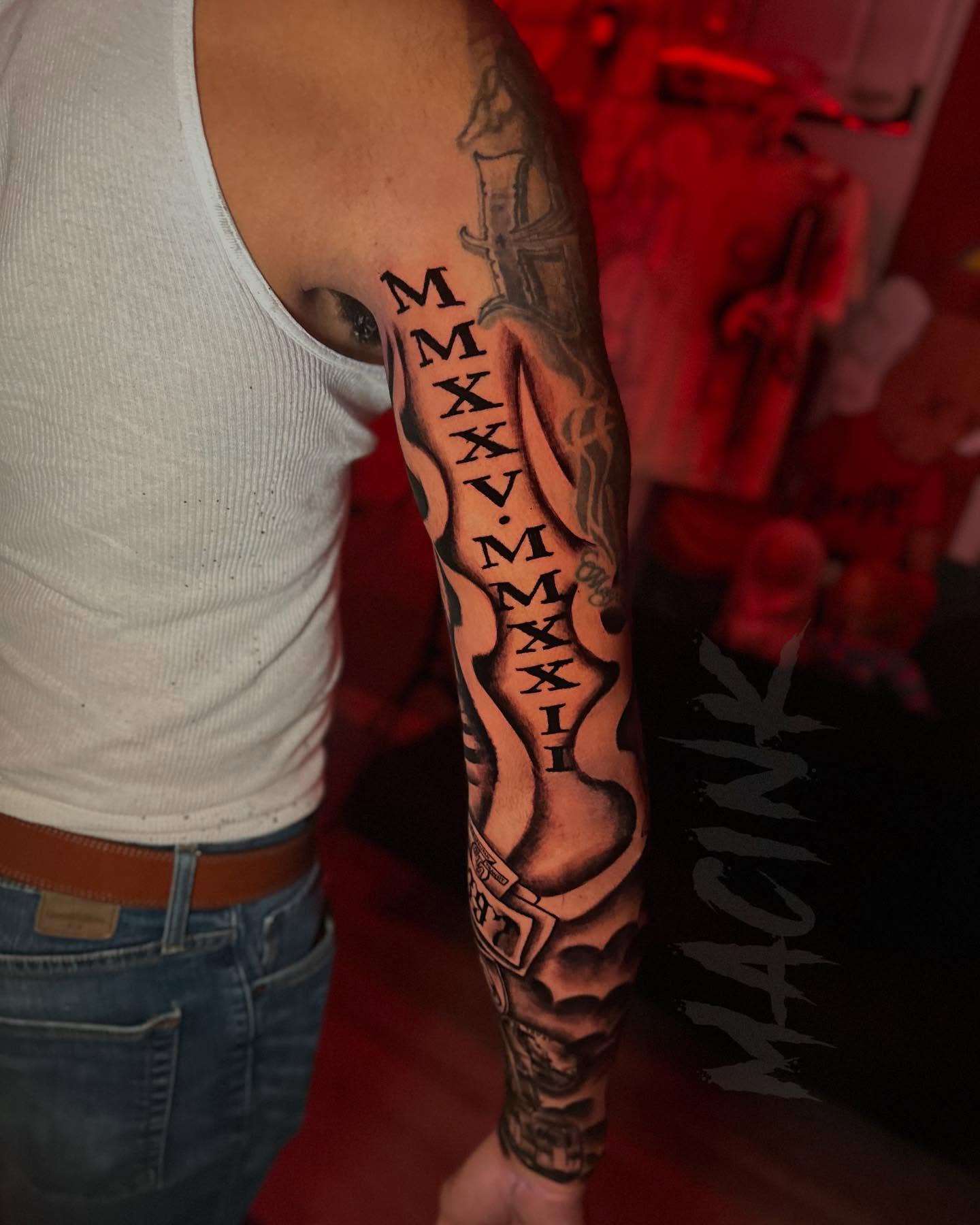 Roman numerals black and grey tattoo on the forearm by ATL Tattoo Artist💲