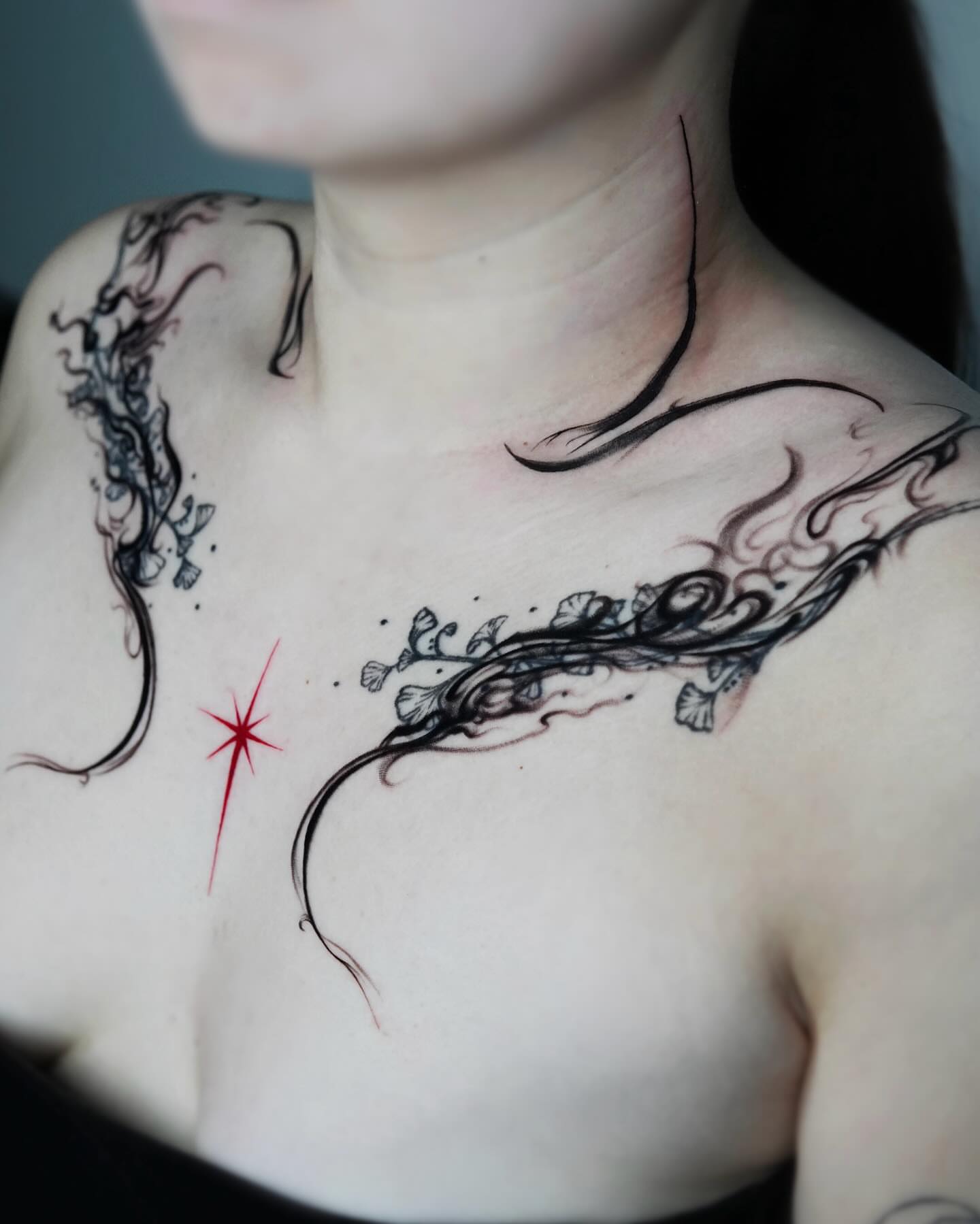 Abstract floral vine ornamental tattoo on the chest by Yeye