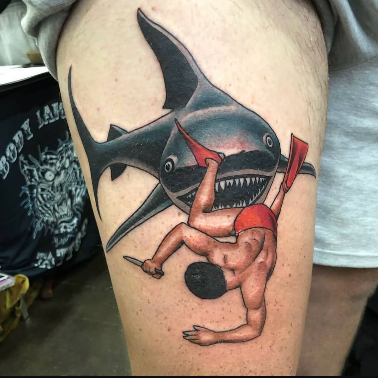 Shark attack scene American traditional tattoo on the thigh by Levi Cox, Powell, Ohio