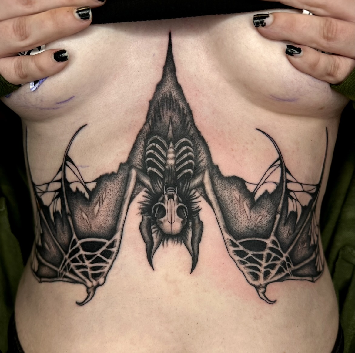 Bat geometric tattoo on the ribs by Marisa Biddle