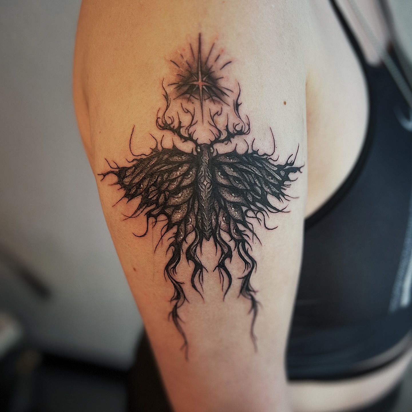 Root system black and grey tattoo on the forearm by Nikki Ward