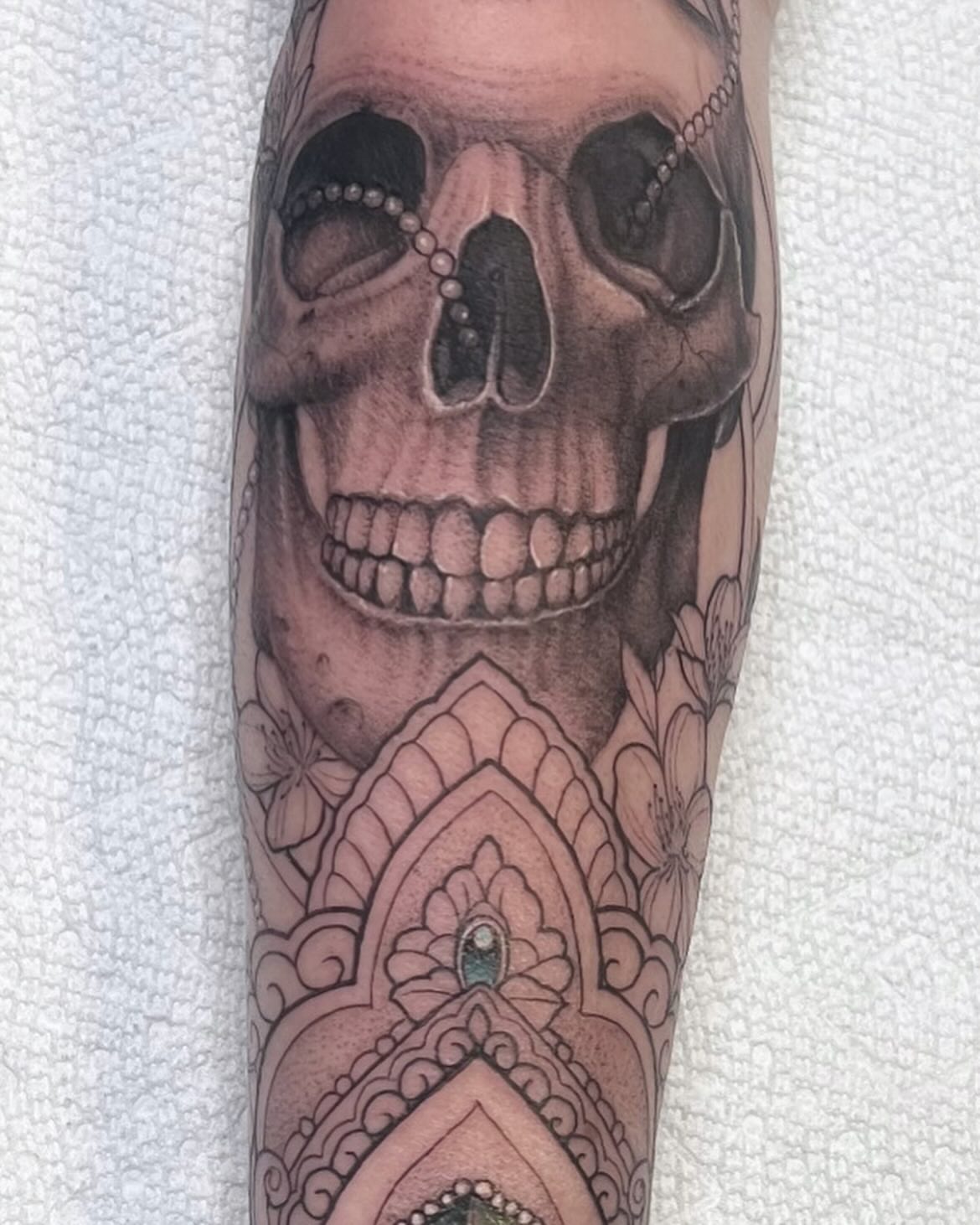 Skull realism tattoo on the forearm by Eric Axle