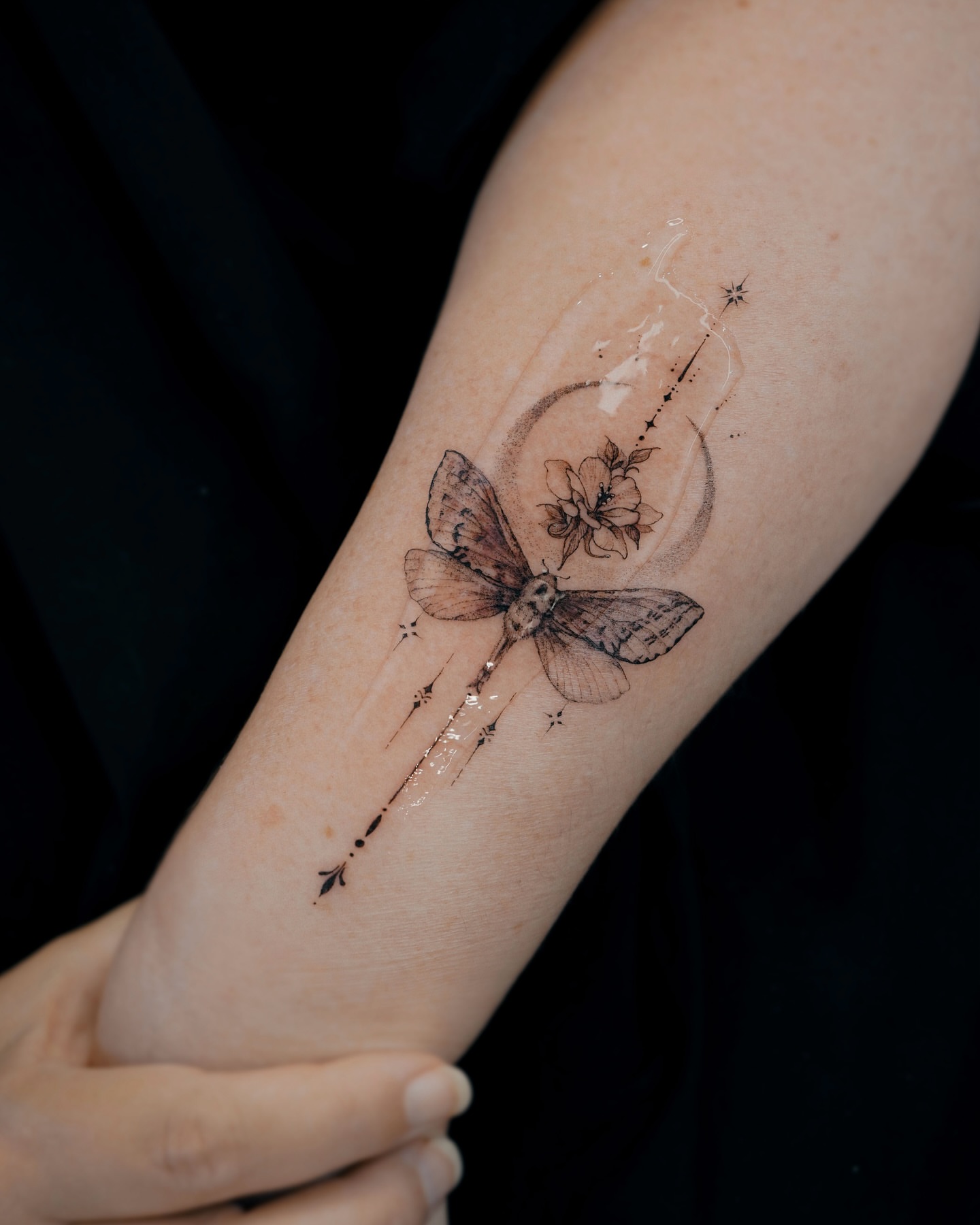 Butterfly and flower realism tattoo on the forearm by Yeonji