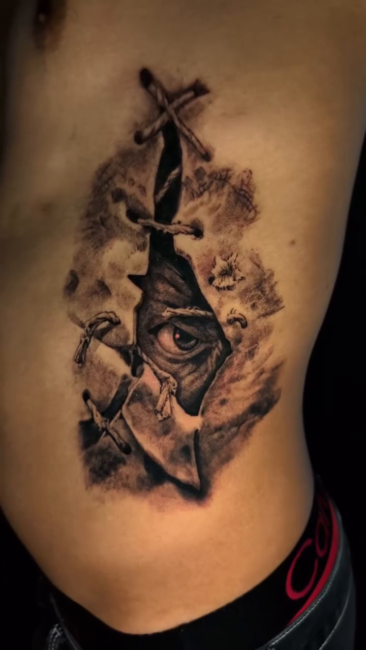 Eye and sword through torn skin dark realism tattoo by Miami Florida Tattoo Artist