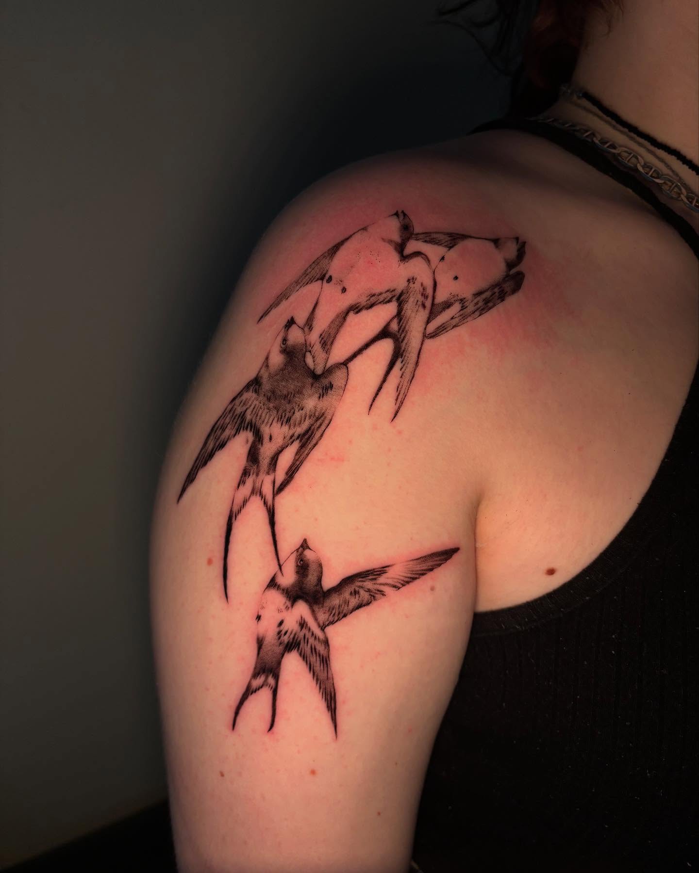 Swallows black and grey tattoo on the shoulder by sanjai