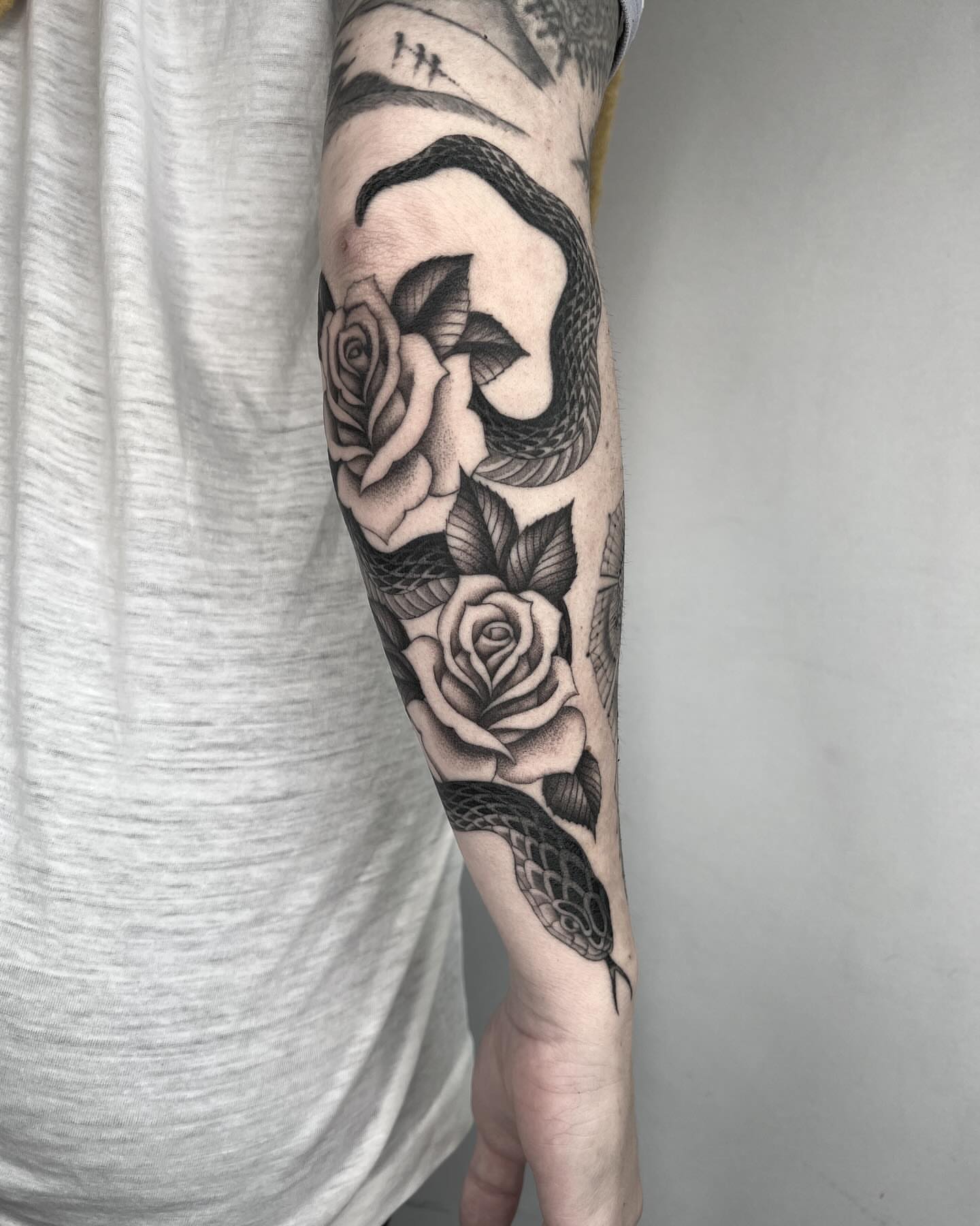 Snake and roses realism tattoo on the forearm by linahsiaotattoo