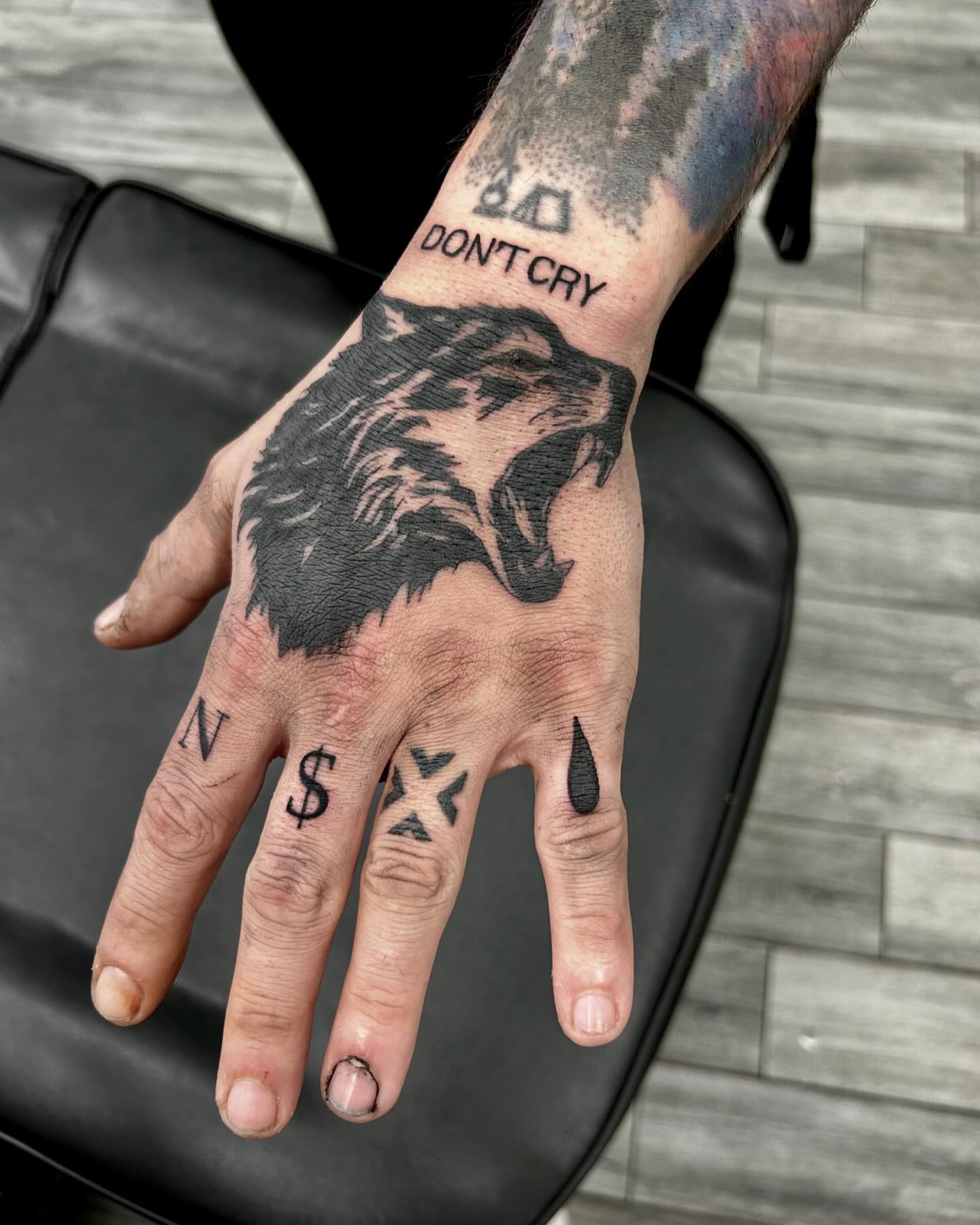 Wolf black and grey tattoo on the hand by Brittany Brutal