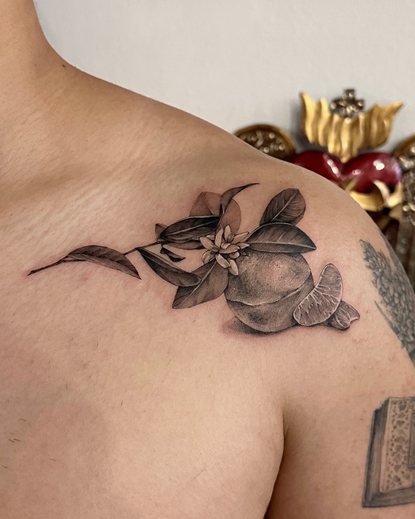 Orange and leaves realism tattoo on the shoulder by Soohee Jin✨ NYC tattoo artist