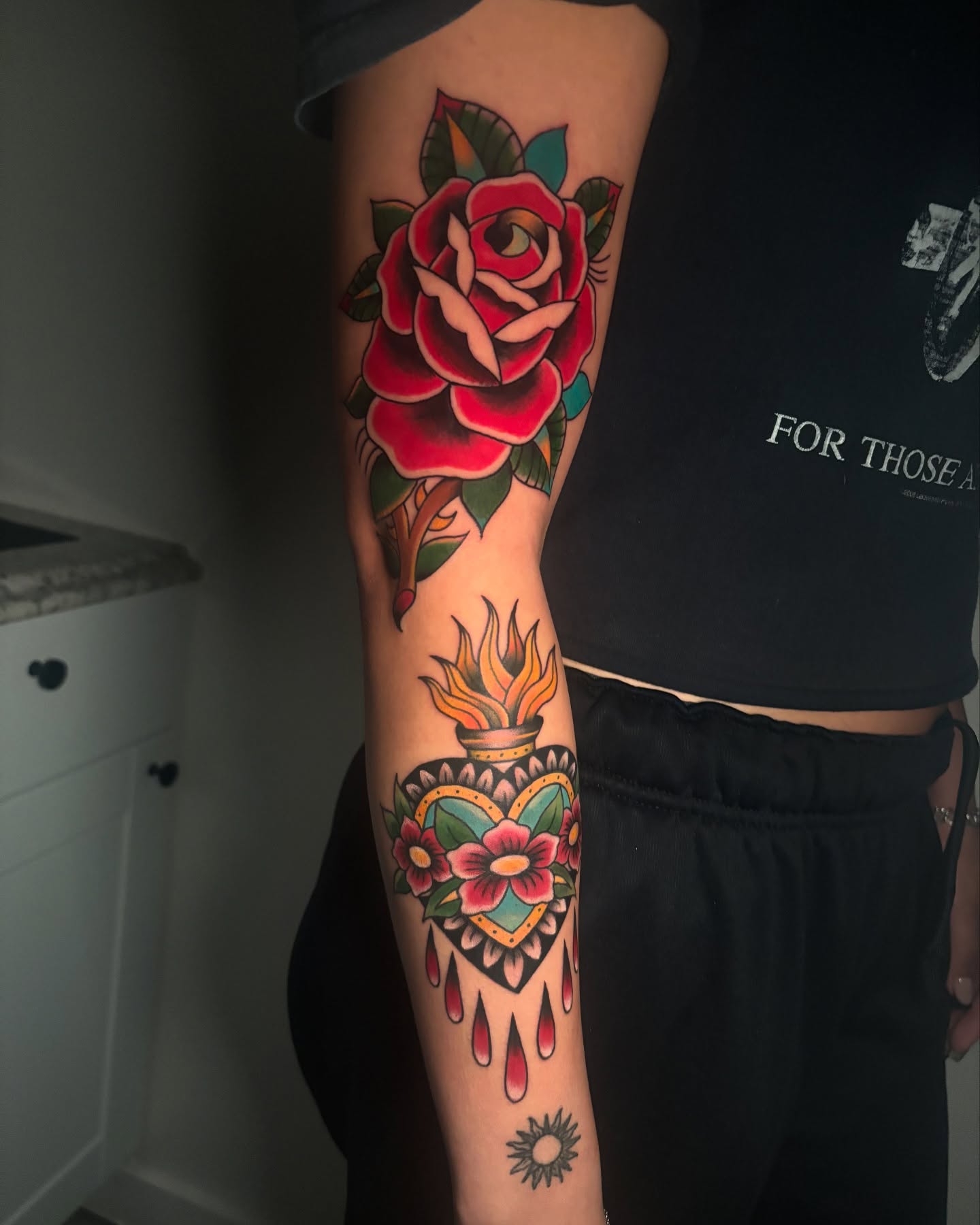 Rose and heart American traditional tattoo on the forearm by Eric Garcia