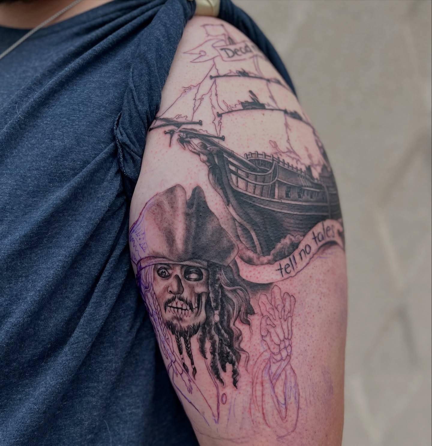 Pirate ship and skeleton black and grey tattoo on the shoulder by Angelique Sanders, Tellico Plains, Tennessee