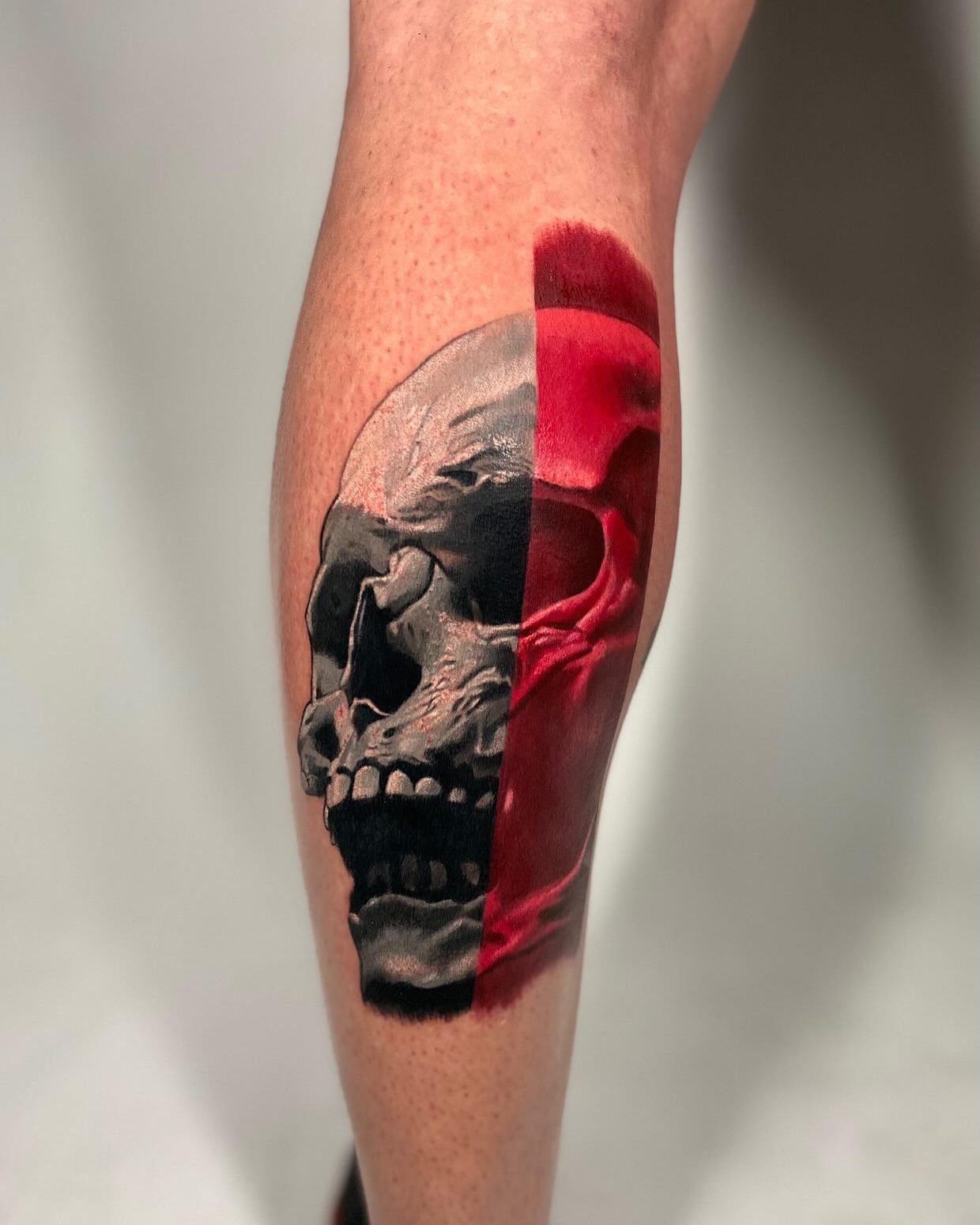 Skull realism tattoo on the calf by Robert Morton, Cleveland, Ohio