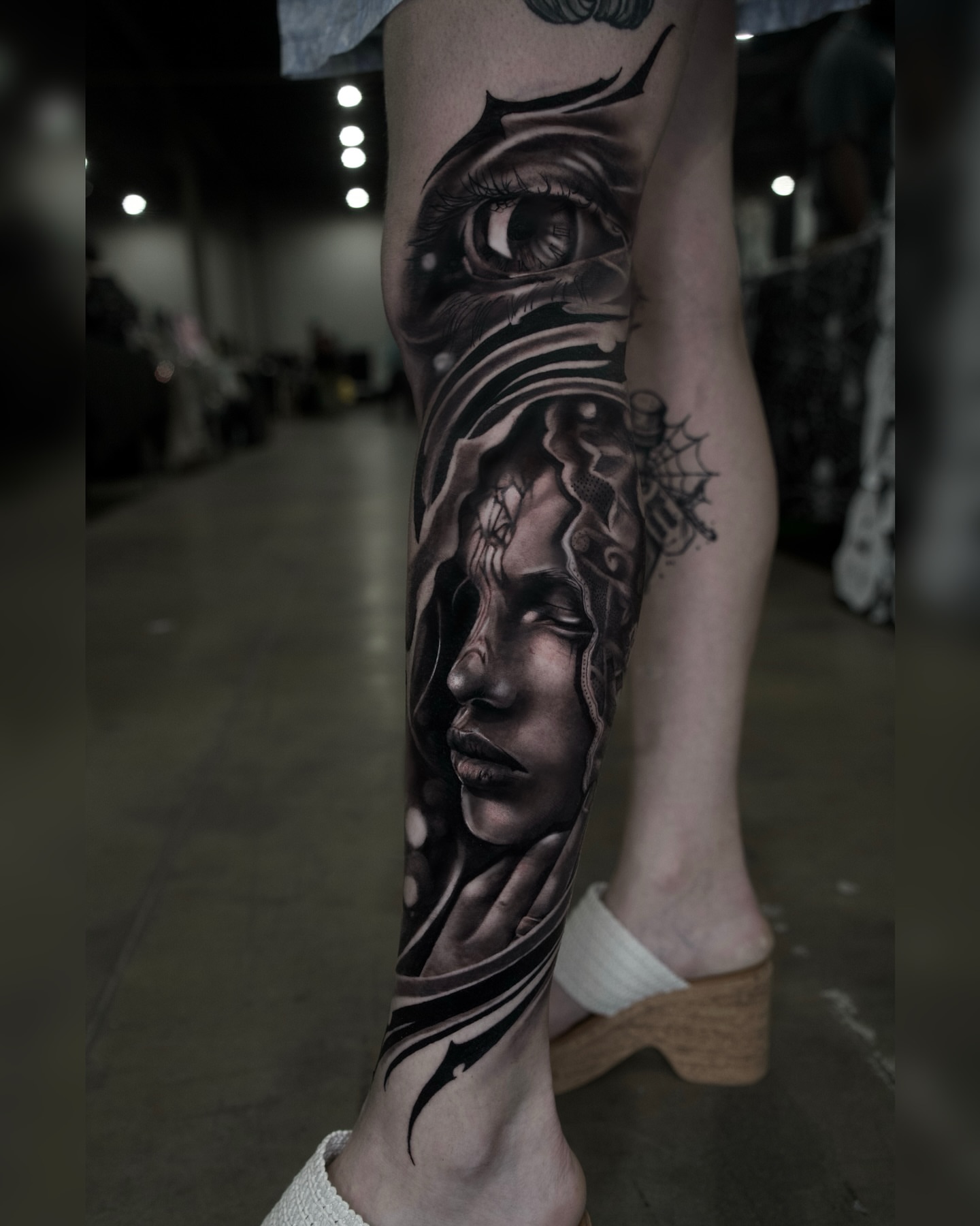 Abstract face realism tattoo on the calf by Diego Andrés Cárdenas