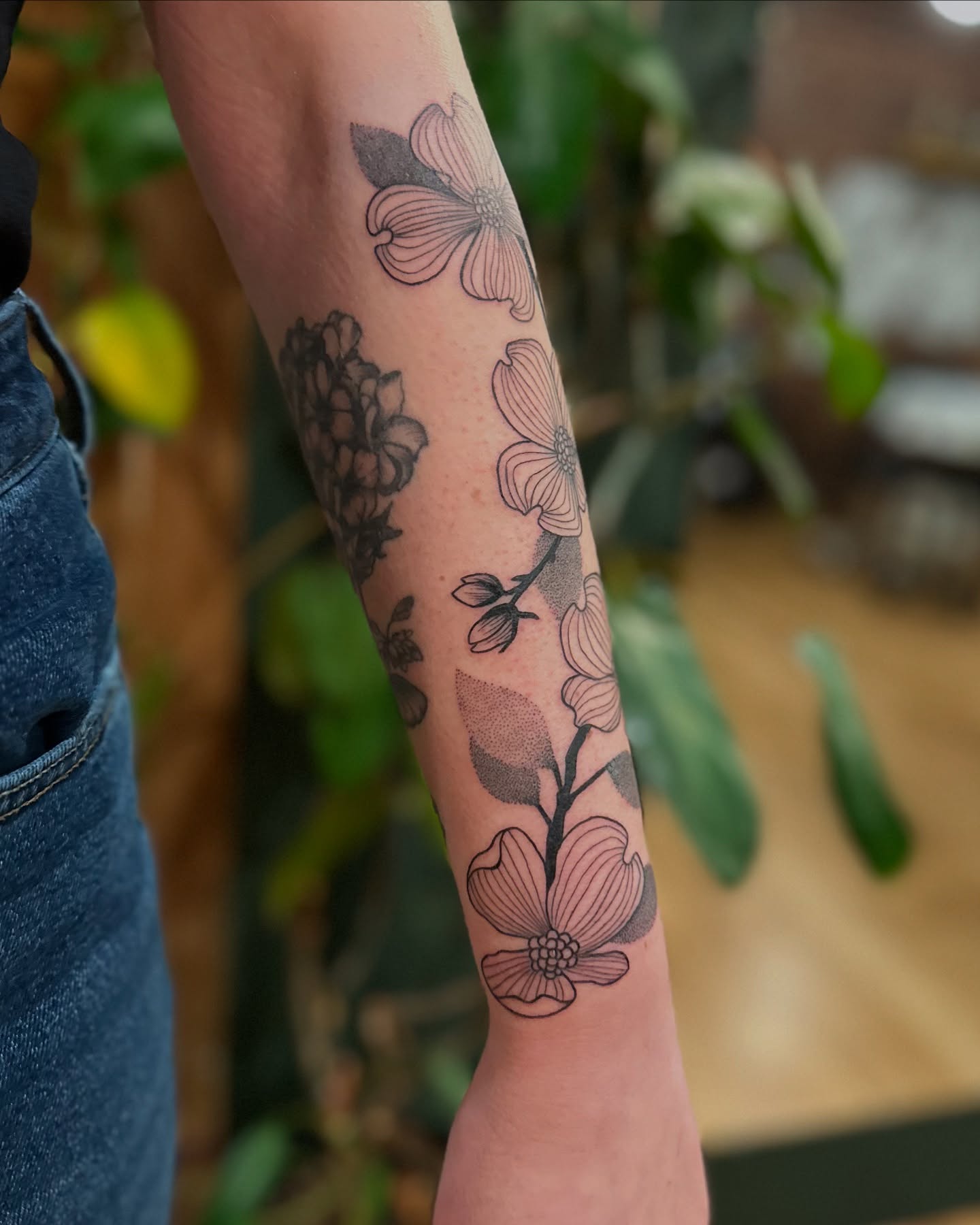 Flower bouquet black and grey tattoo on the forearm by Alexandra Gray
