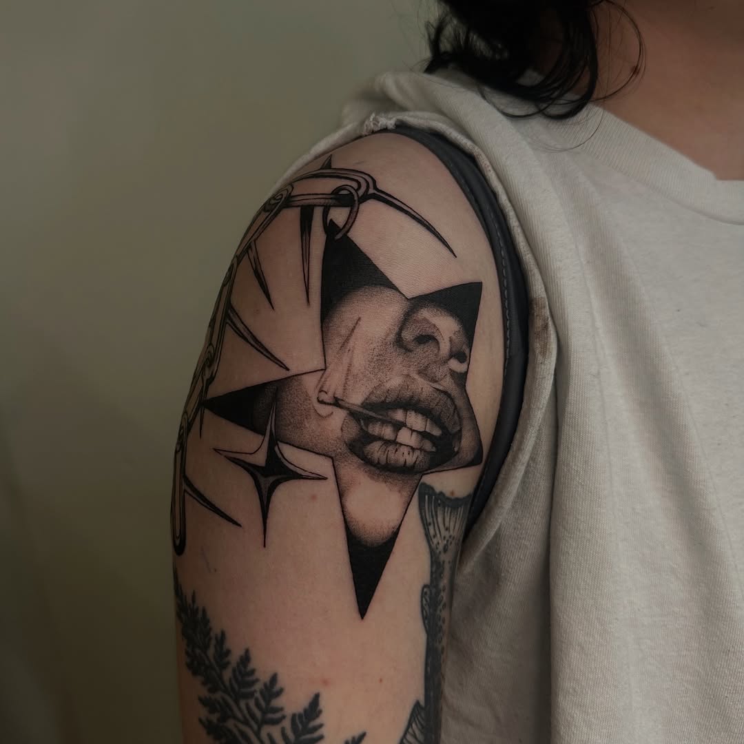 Face in star with cigarette realism tattoo on the shoulder by Kait