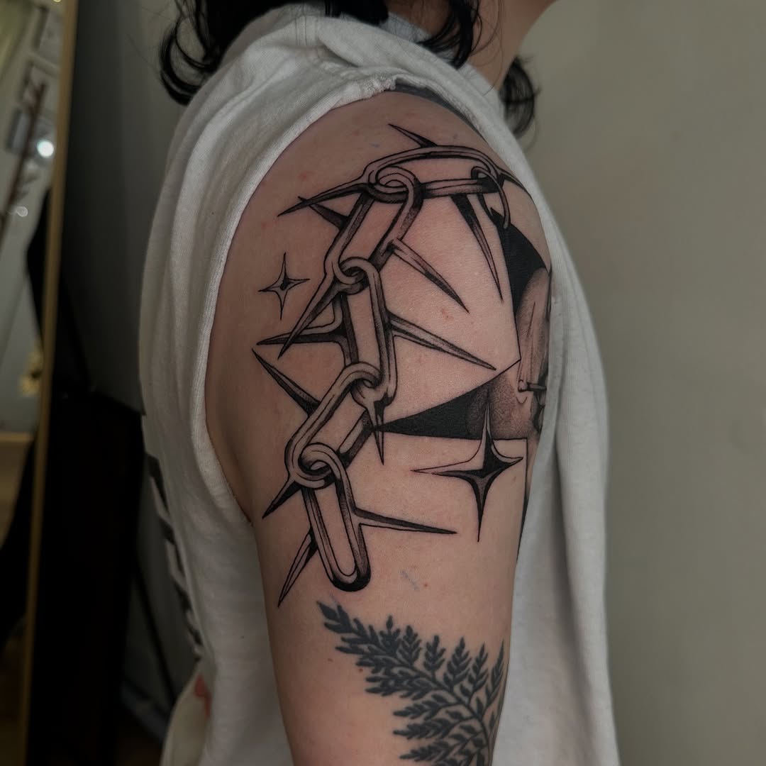 Spiked chain and abstract shapes cyber sigilism tattoo on the upper arm by Kait