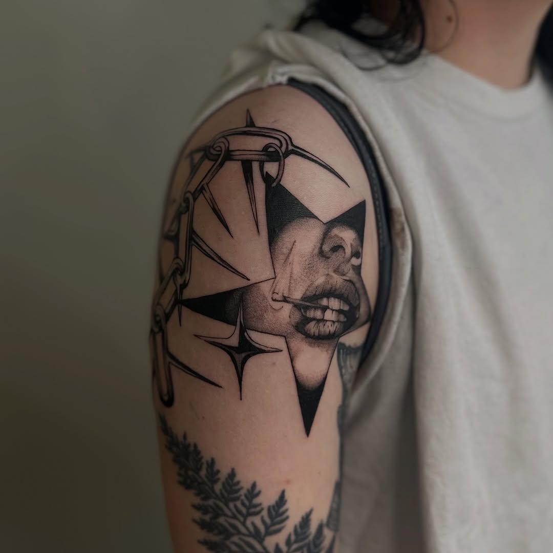 Face and chain within a star cyber sigilism tattoo on the shoulder by Kait