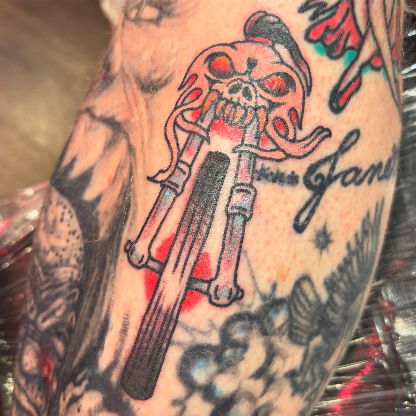 Skull and guitar American traditional tattoo on the forearm by @dannydoestattoos