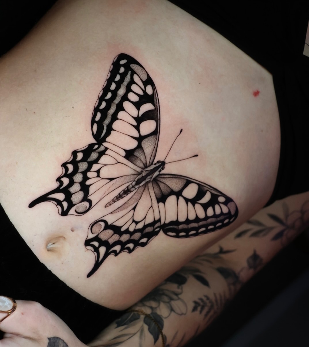 Butterfly black and grey tattoo on the thigh by Jesus Bravo