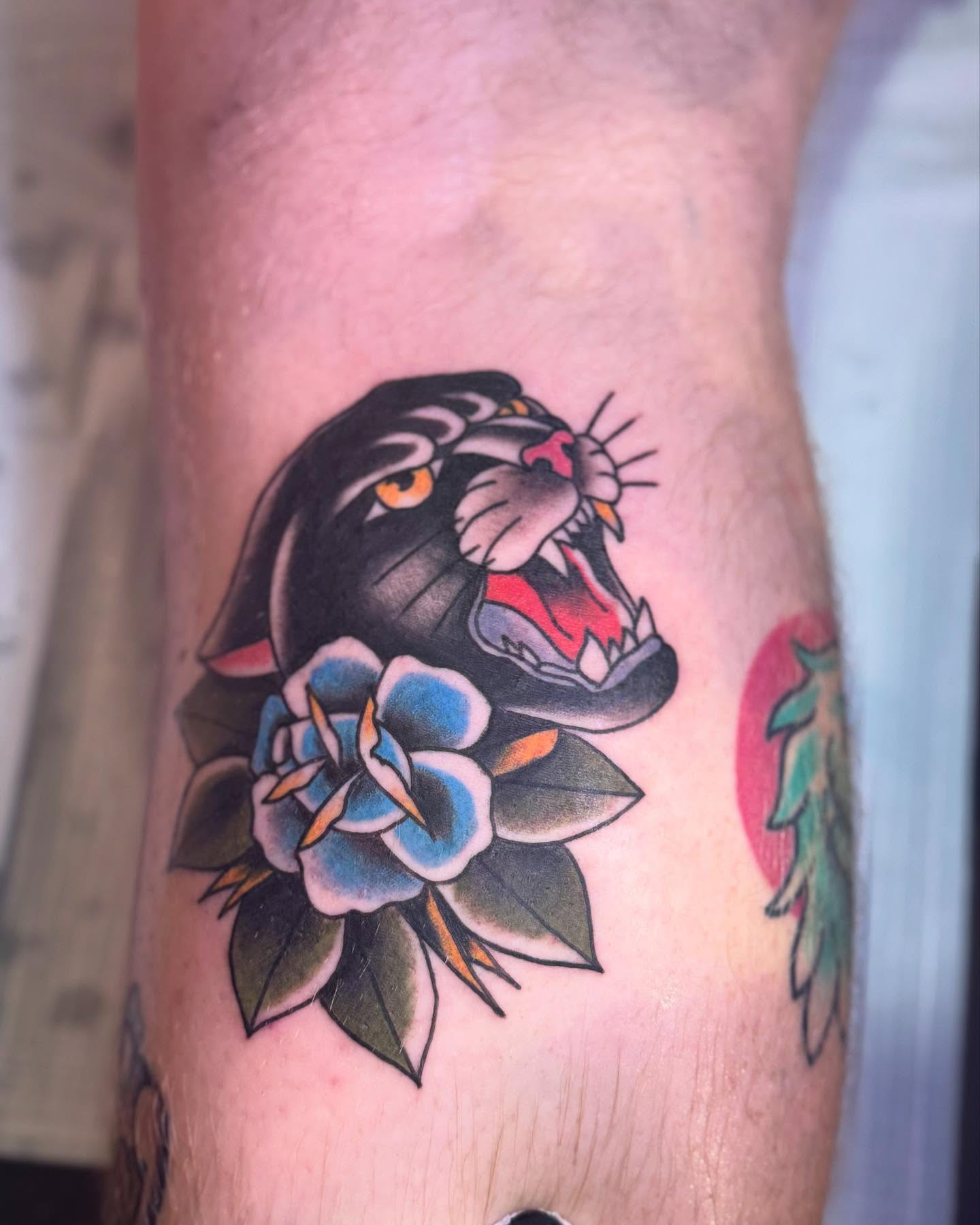 Panther and flowers American traditional tattoo on the forearm by Robbie Roberson