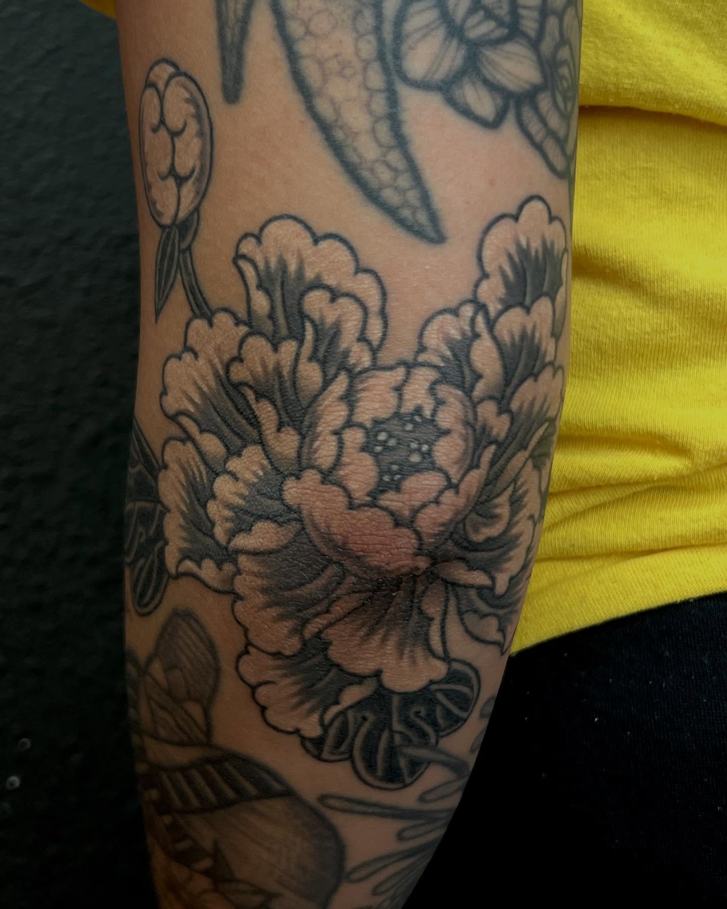 Peony flowers black and grey tattoo on the forearm by Rocky Burley, Georgetown, Texas