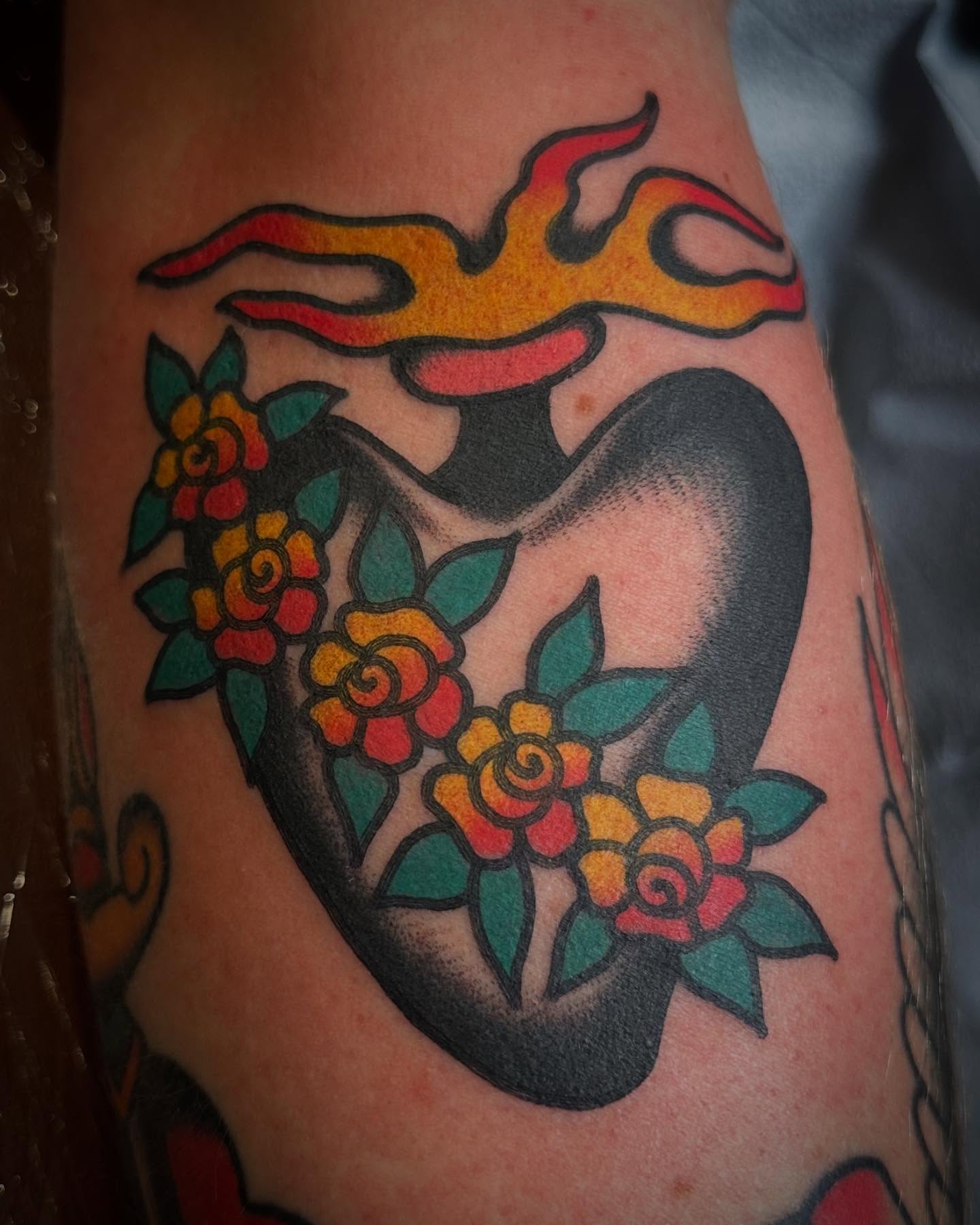 Flame and flowers American traditional tattoo on the forearm by Nathan Rohrbacher, Nashville, Tennessee