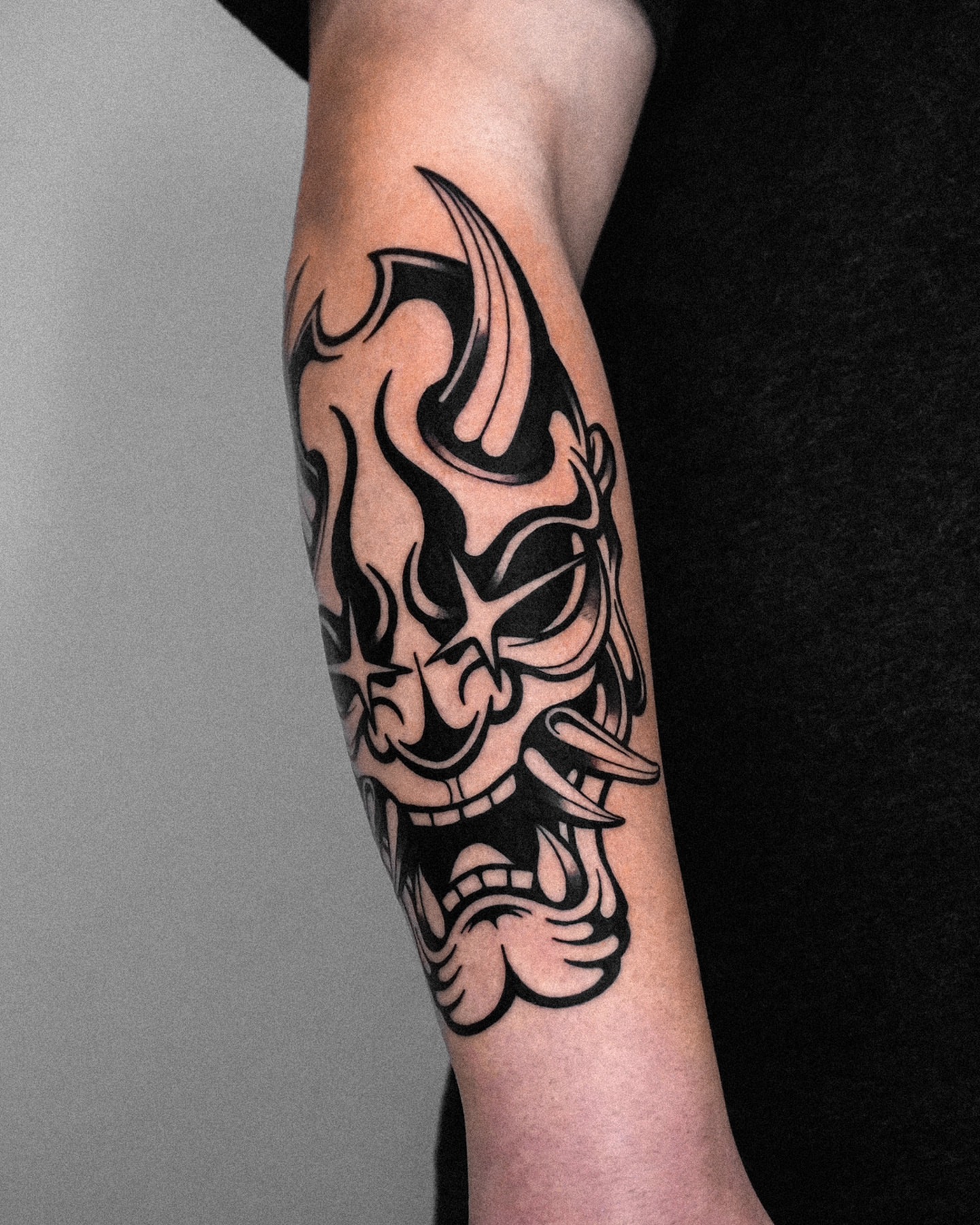 Mask tribal tattoo on the forearm by Jeremy "Jerms" Camposanto