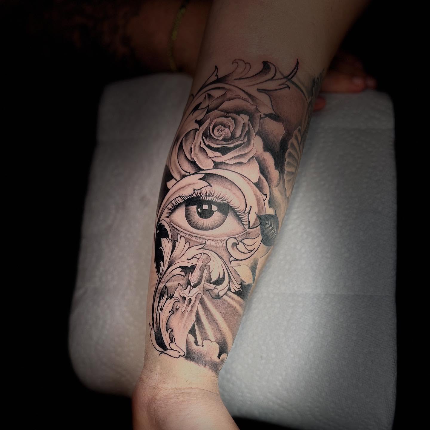 Eye and roses realism tattoo on the forearm by Denis Morello de Castro, South River, New Jersey