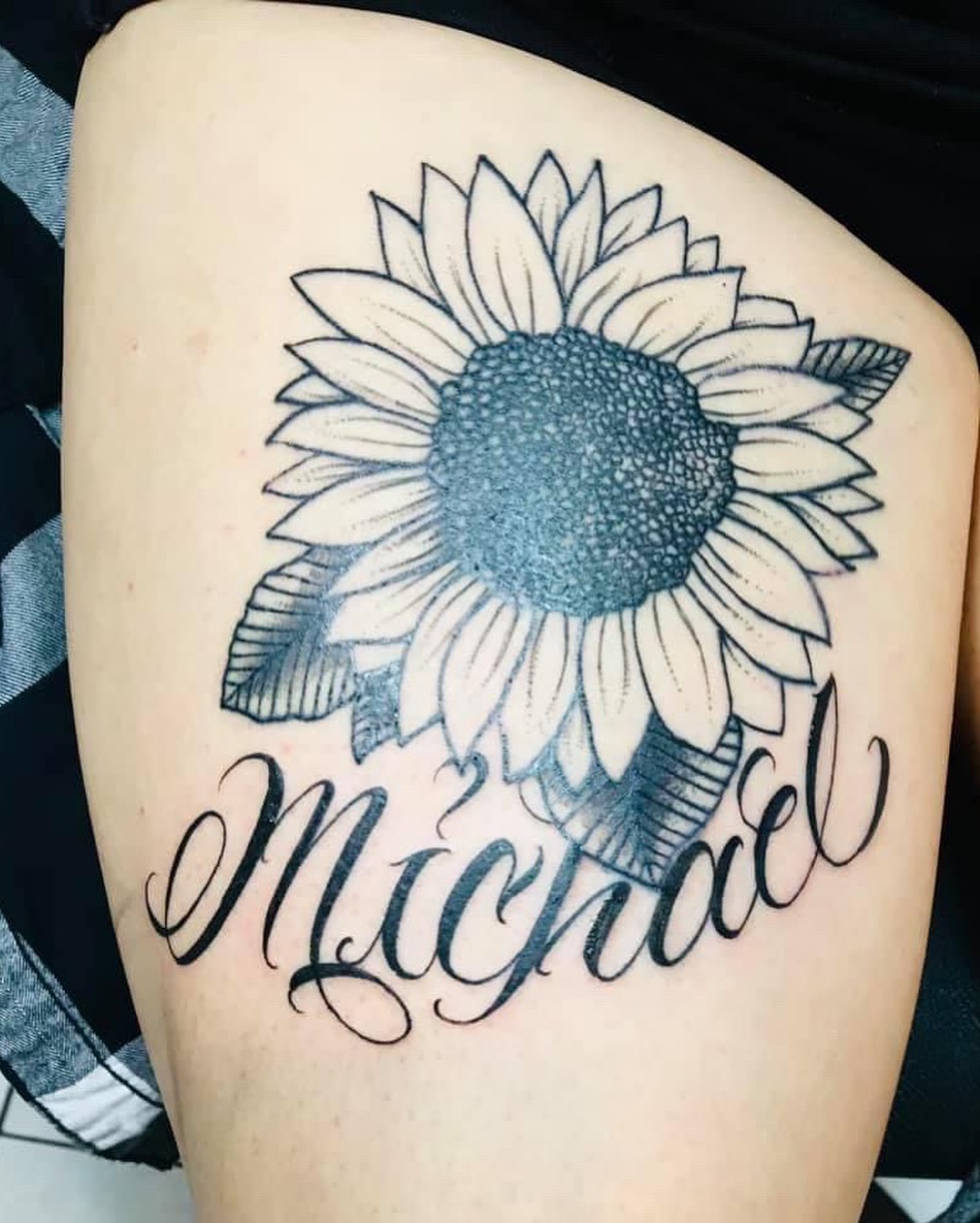 Sunflower black and grey tattoo on the thigh by Kiki Tattoos😈