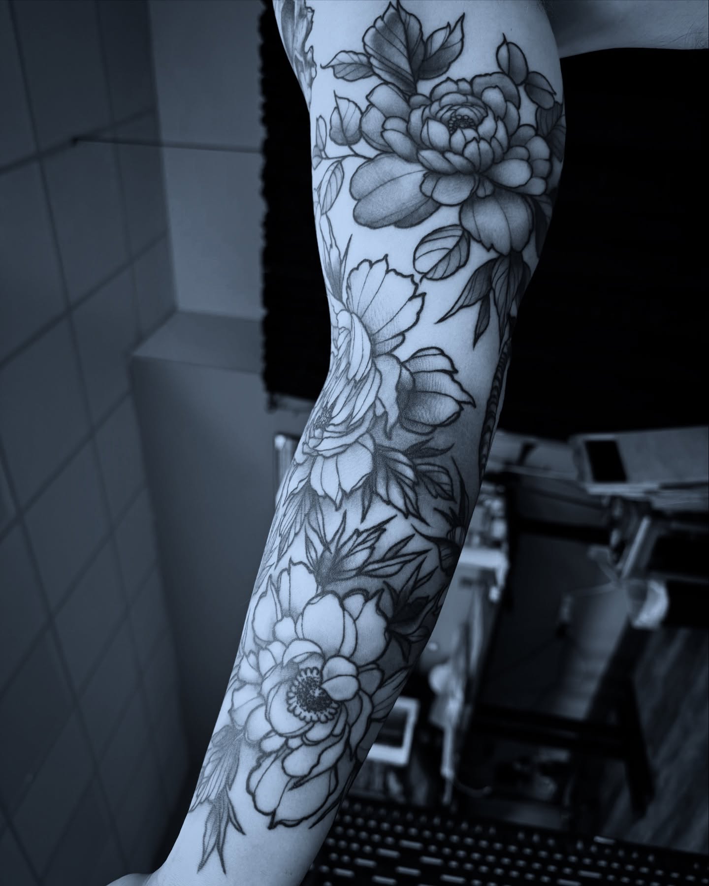 Floral bouquet black and grey tattoo on the forearm by Michael Langdale