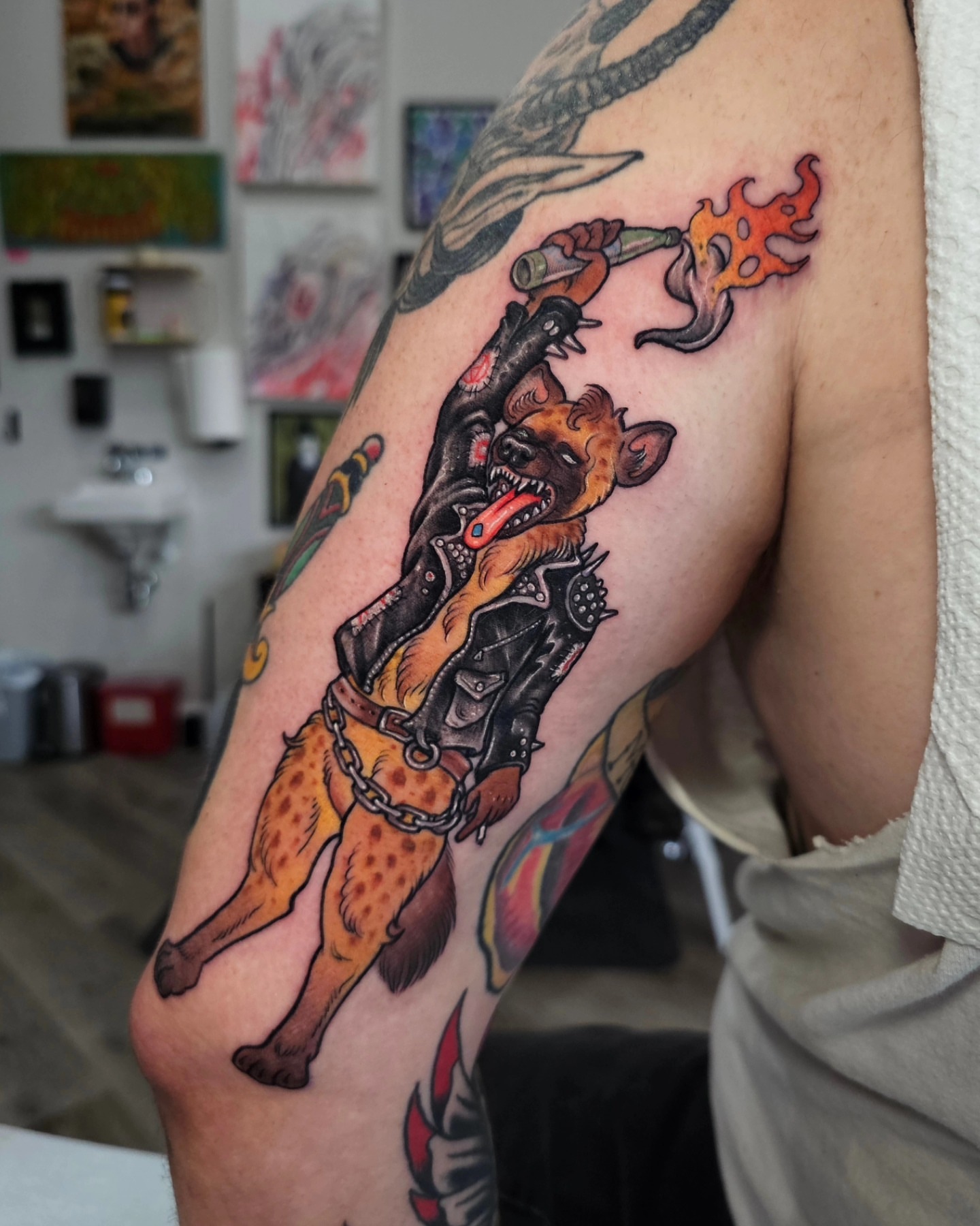 Hyena with torch American traditional tattoo on the forearm by Shannon