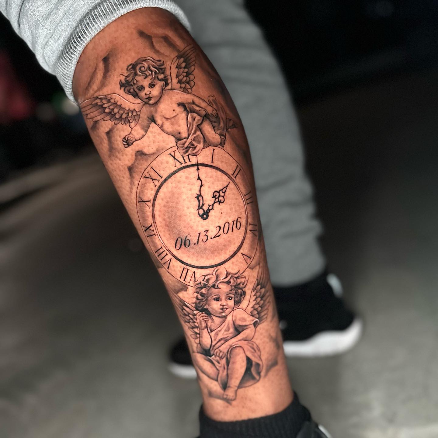 Cherubs and clock realism tattoo on the forearm by Angela Azure