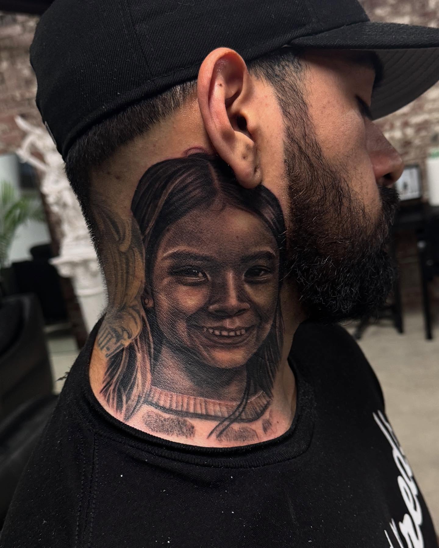 Child's face realism tattoo on the neck by Anthony Duran