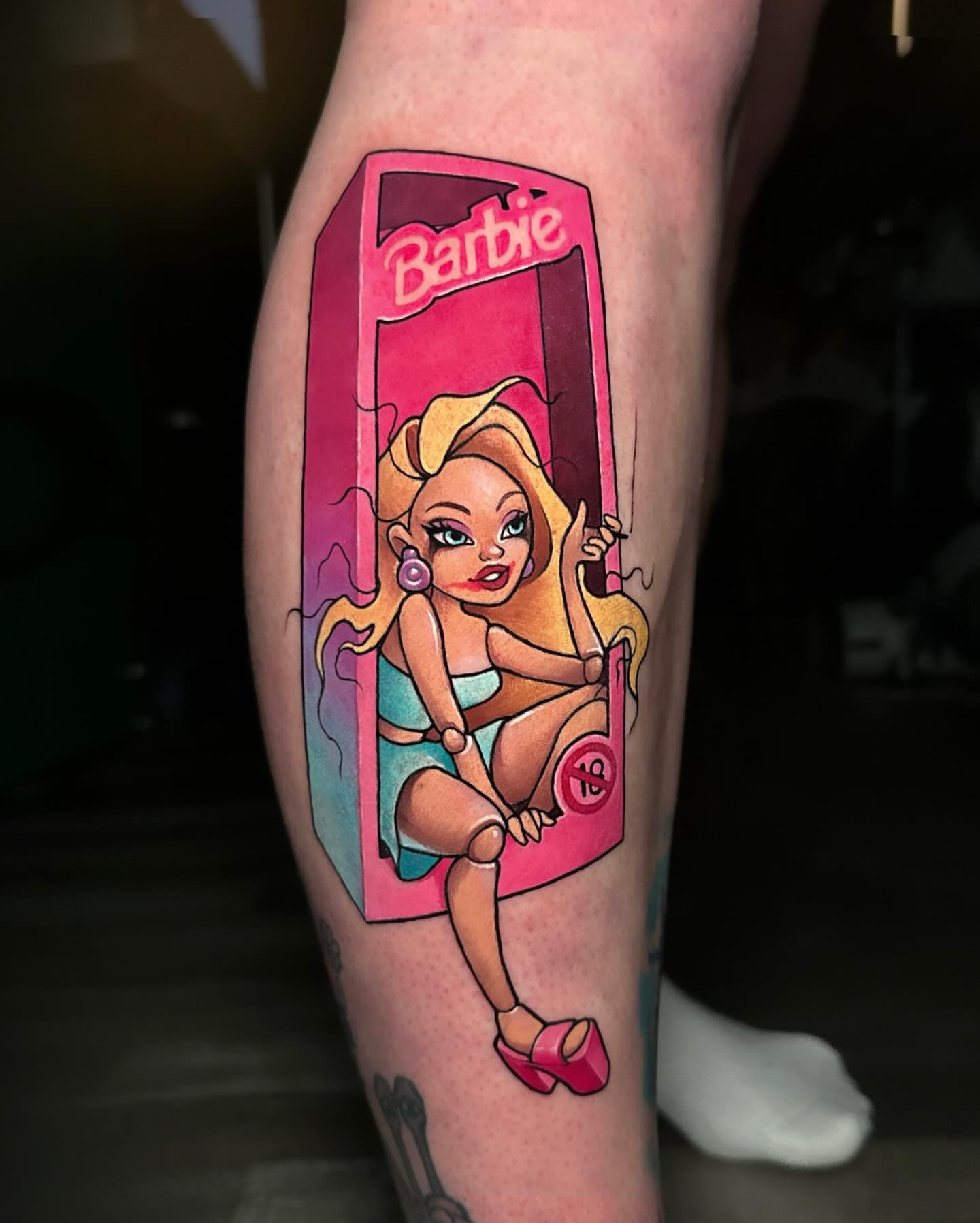 Barbie doll illustrative tattoo on the calf by Lena Aleksandrova